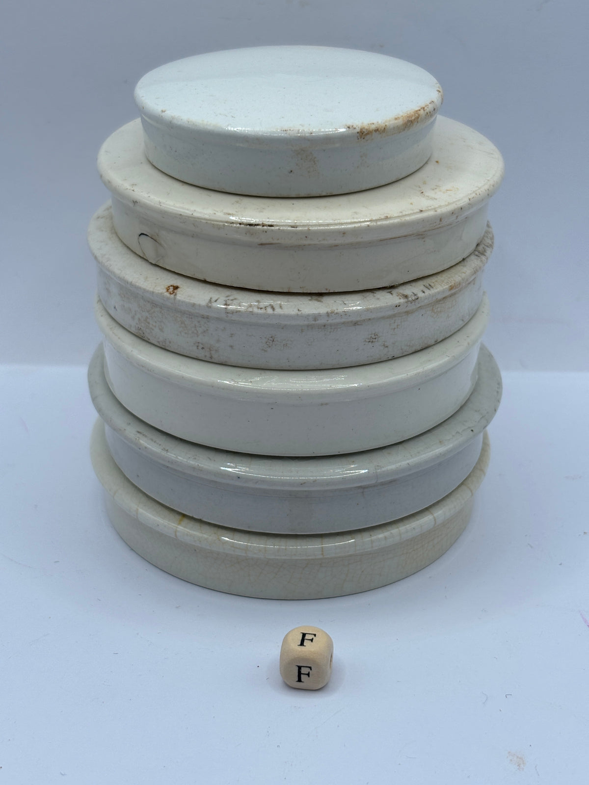 6 old stoneware lids, stackers (F)