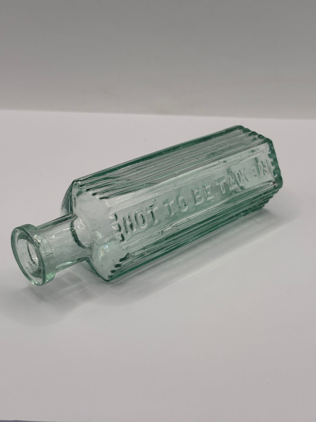 Old aqua glass poison bottle, Not to be taken