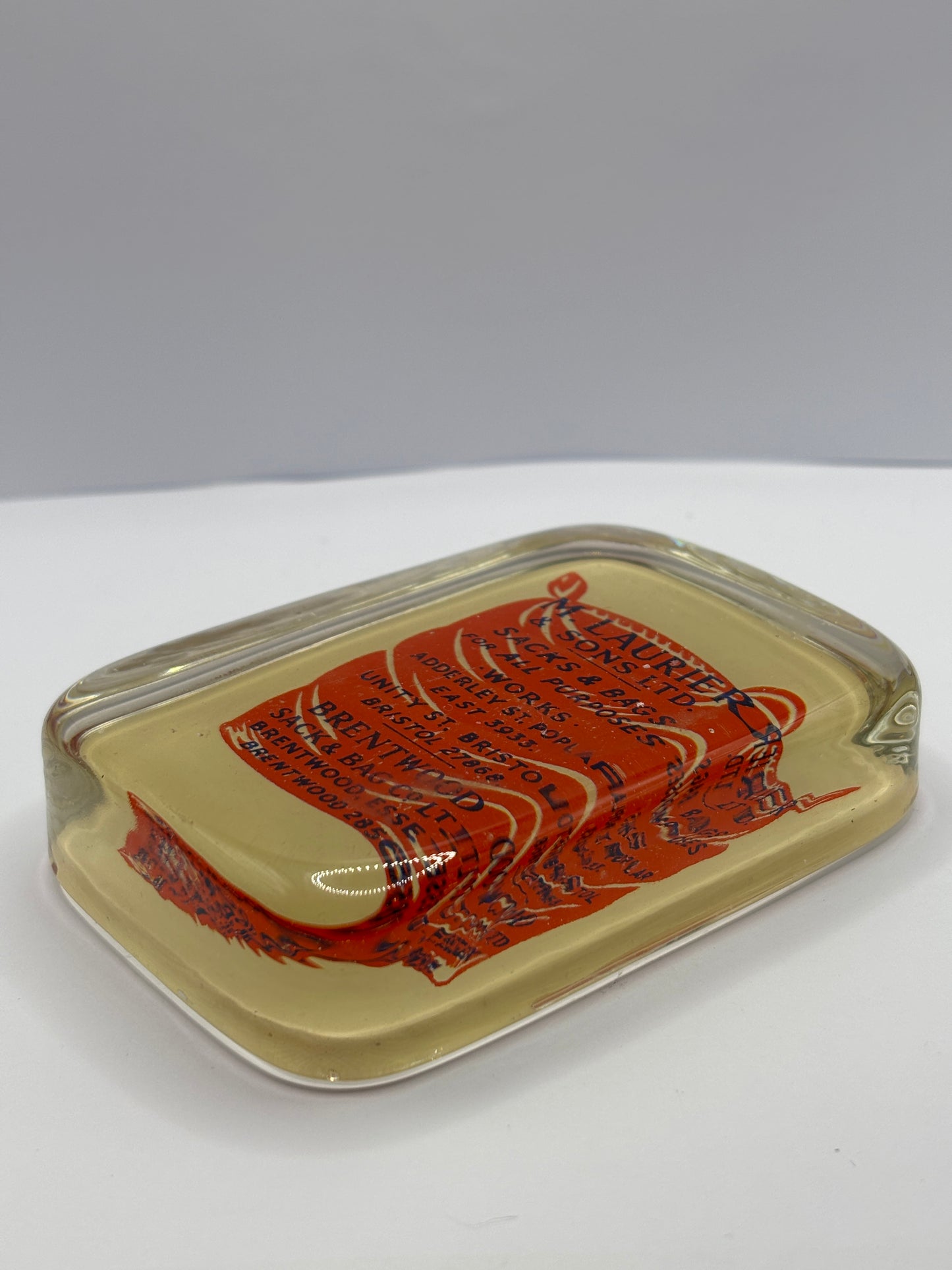 Old glass advertising paperweight. M.laurier & sons sacks & bags