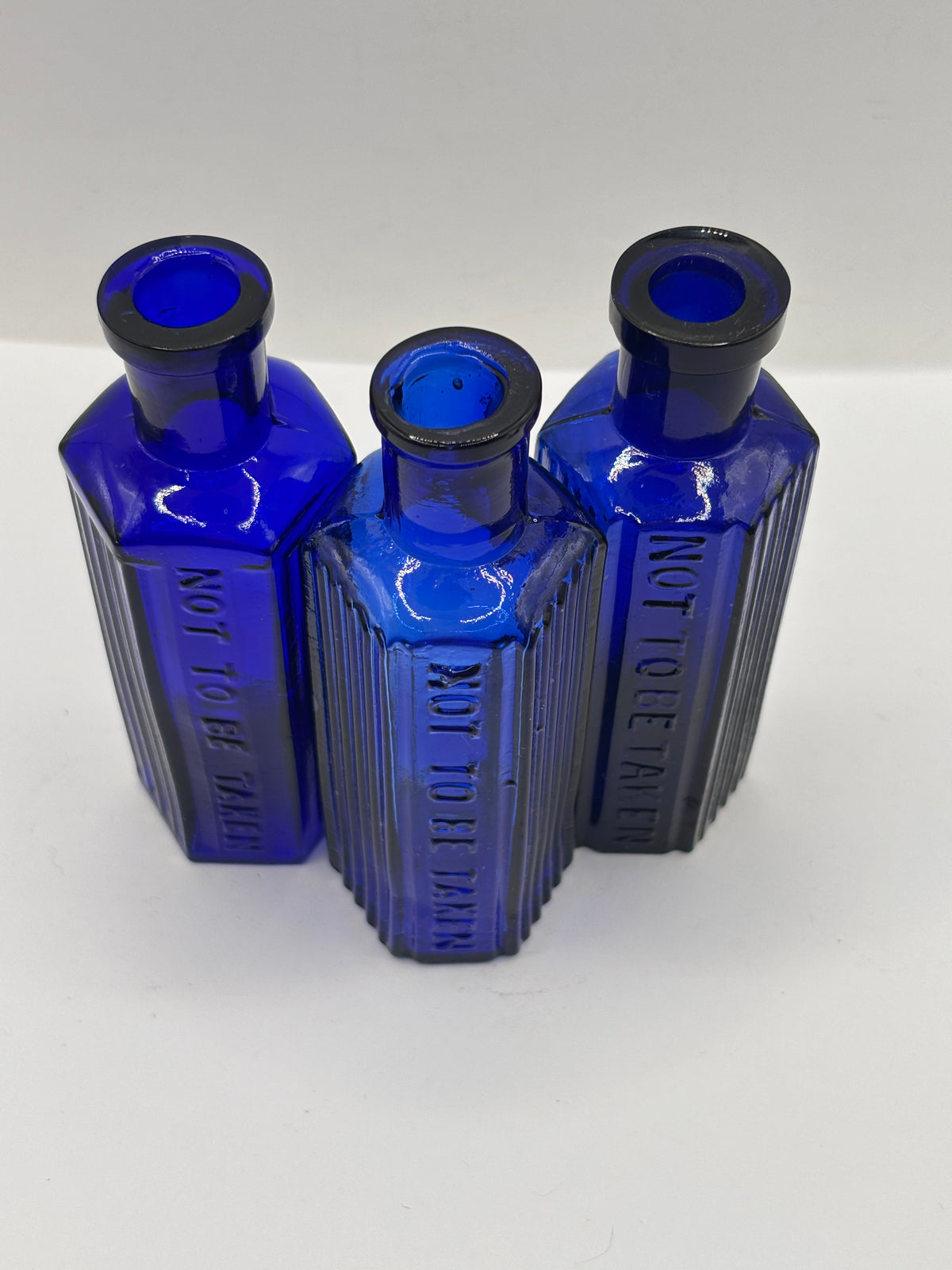 3 old small blue ribbed poison bottles, not to be taken