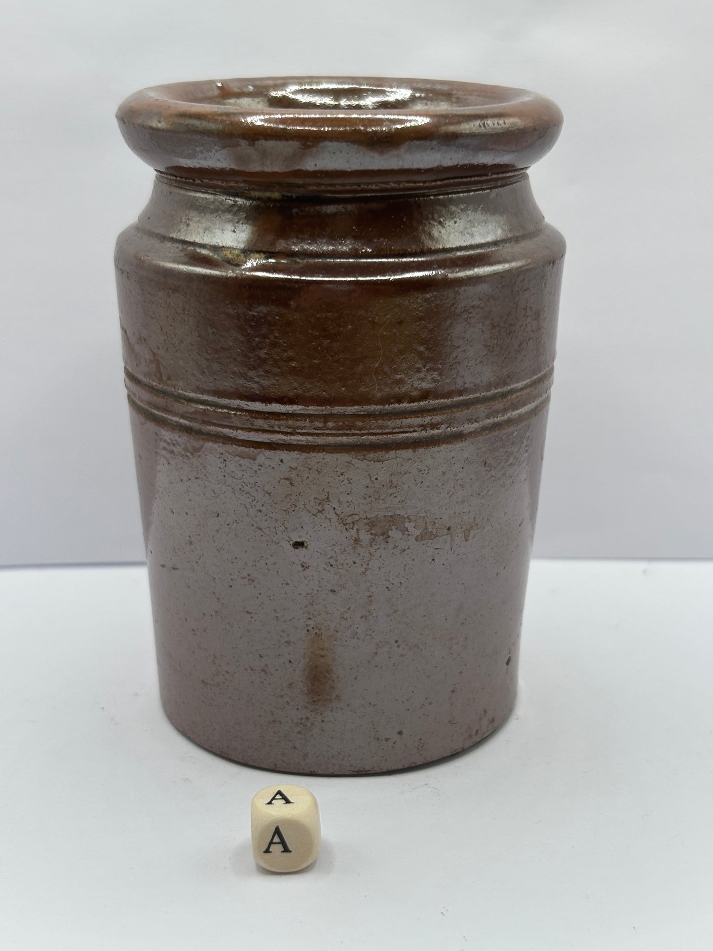 Old brown stoneware jar (a)