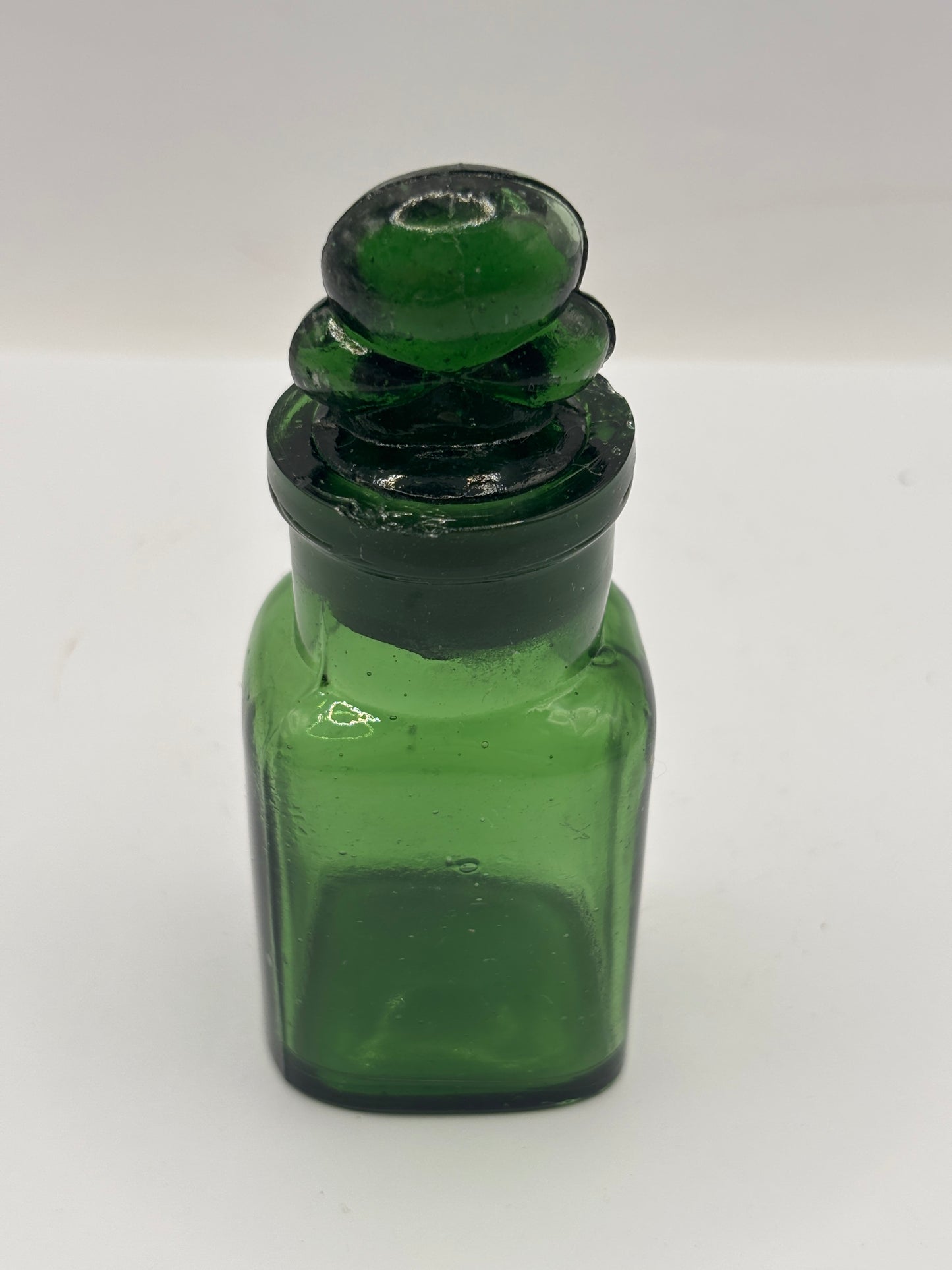 Old green glass smelling salts bottle, chipped