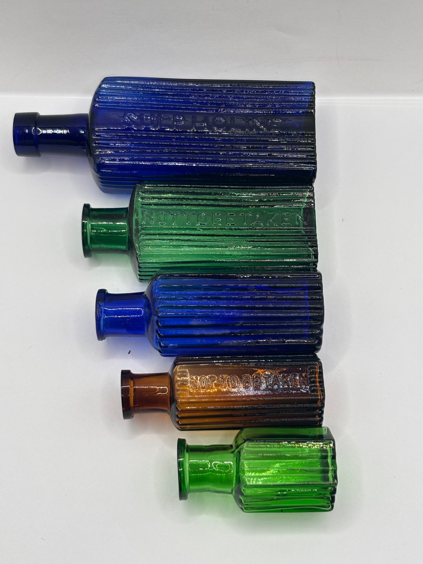 5 old glass poison bottles, not to be taken