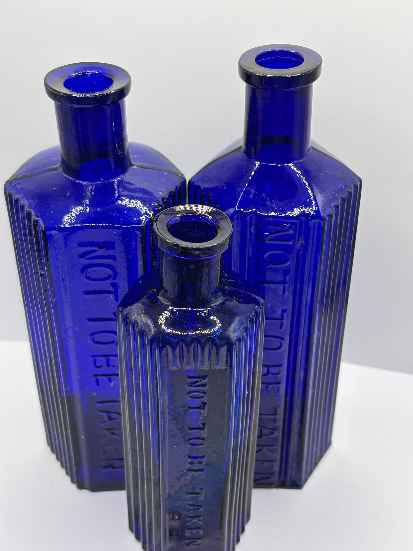 3 old blue poison bottles, not to be taken