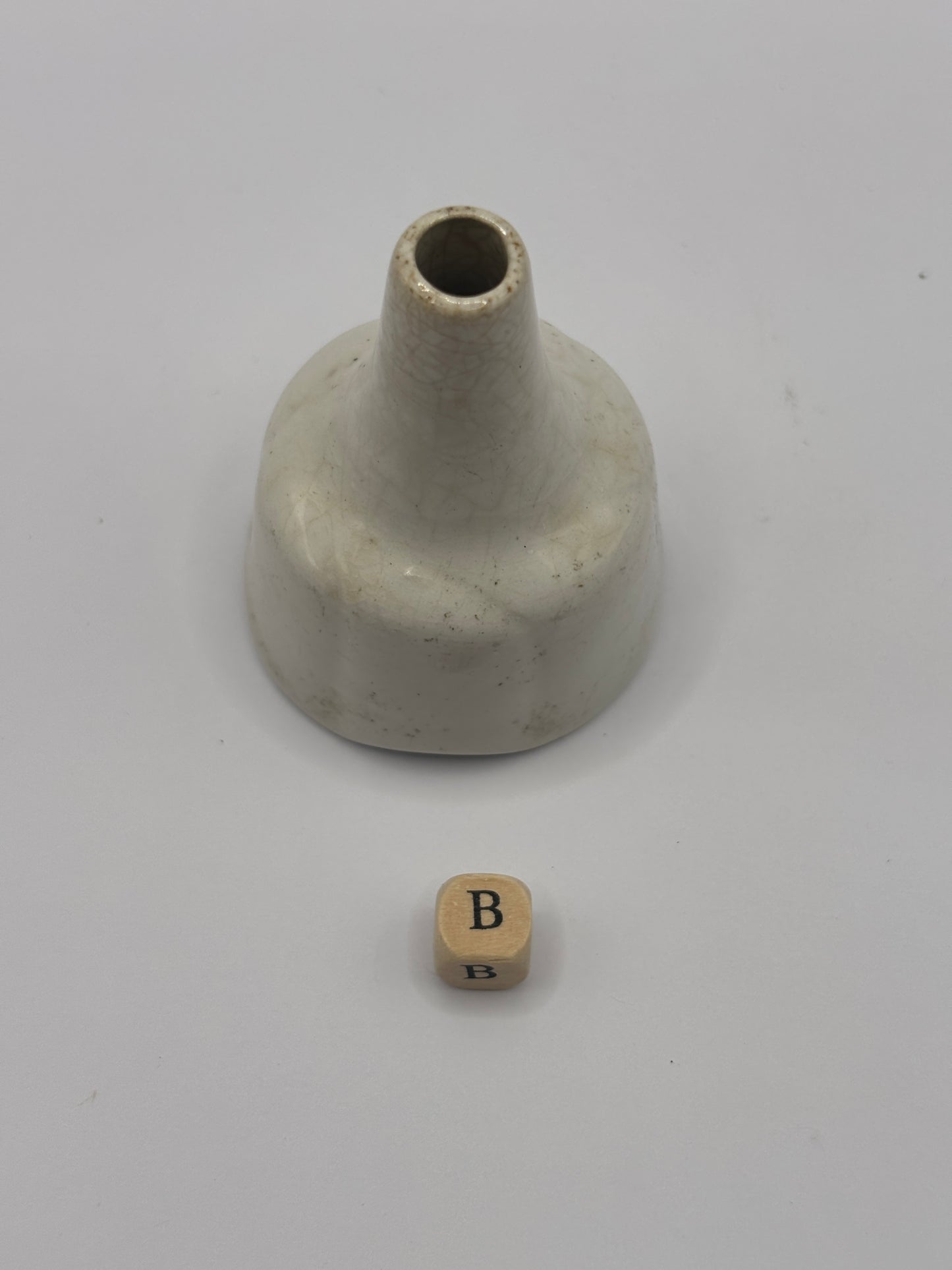 Old white stoneware pie funnel, stained & crazed. Chipped