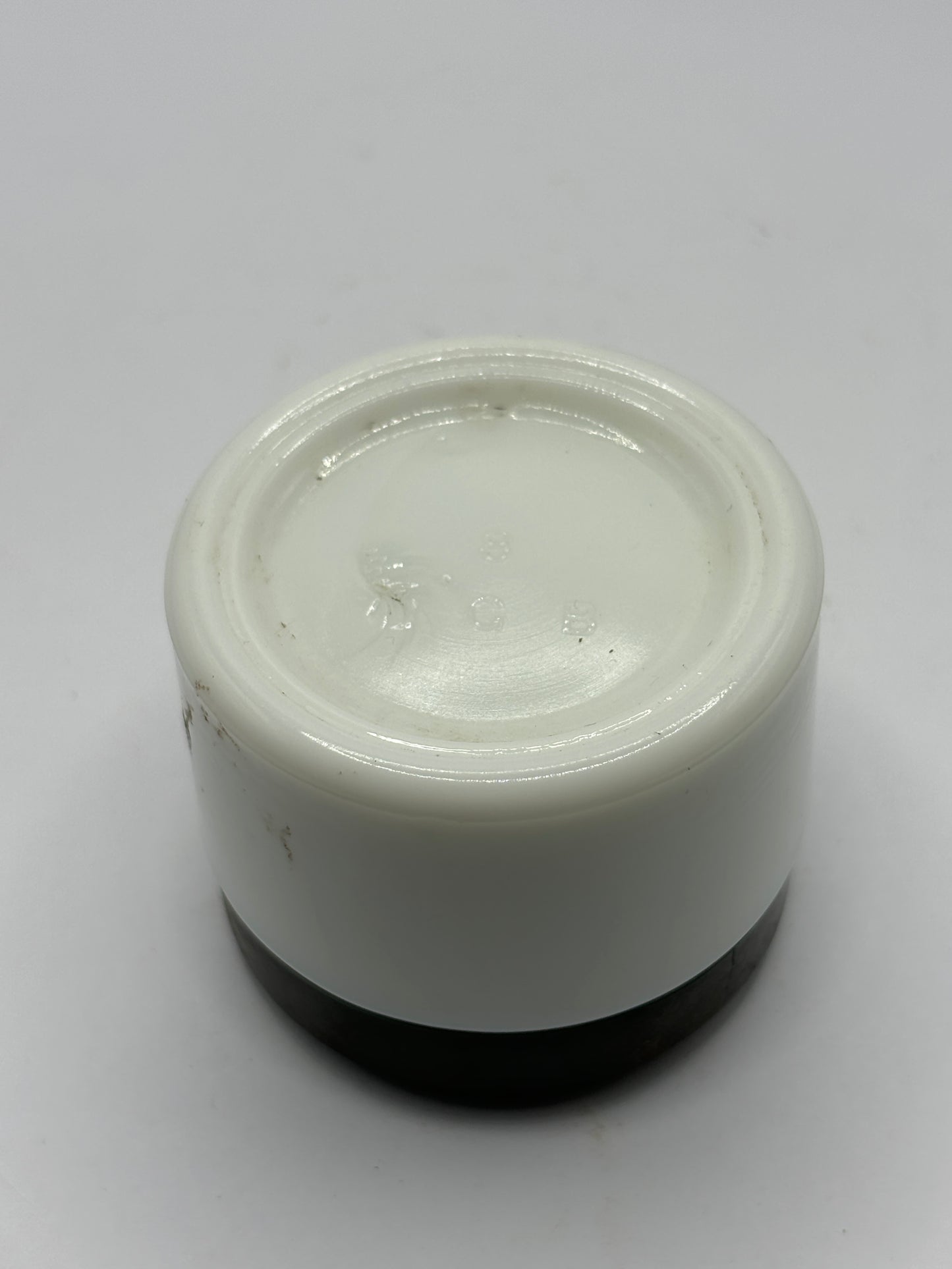 Small milk glass jar with original lid