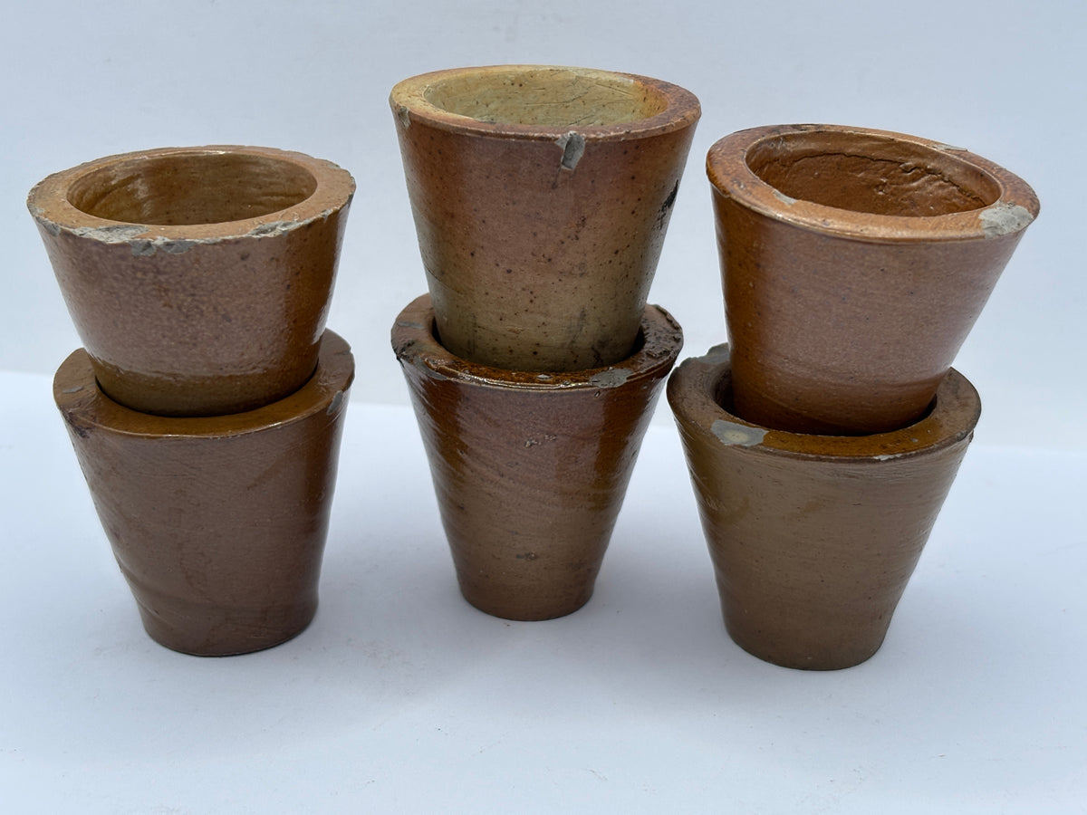 5 small brown stoneware pots. Chipped