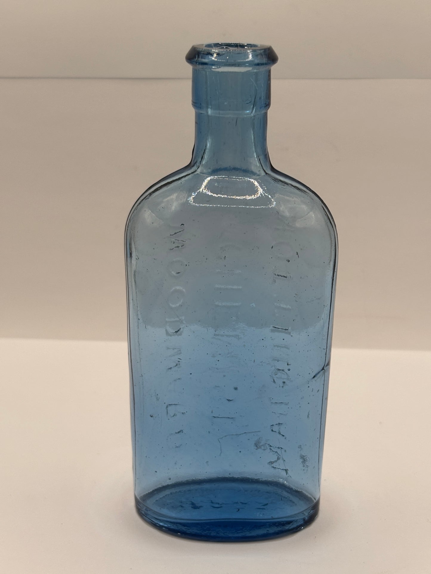 Old blue glass advertising chemist bottle, Woodwards Nottingham