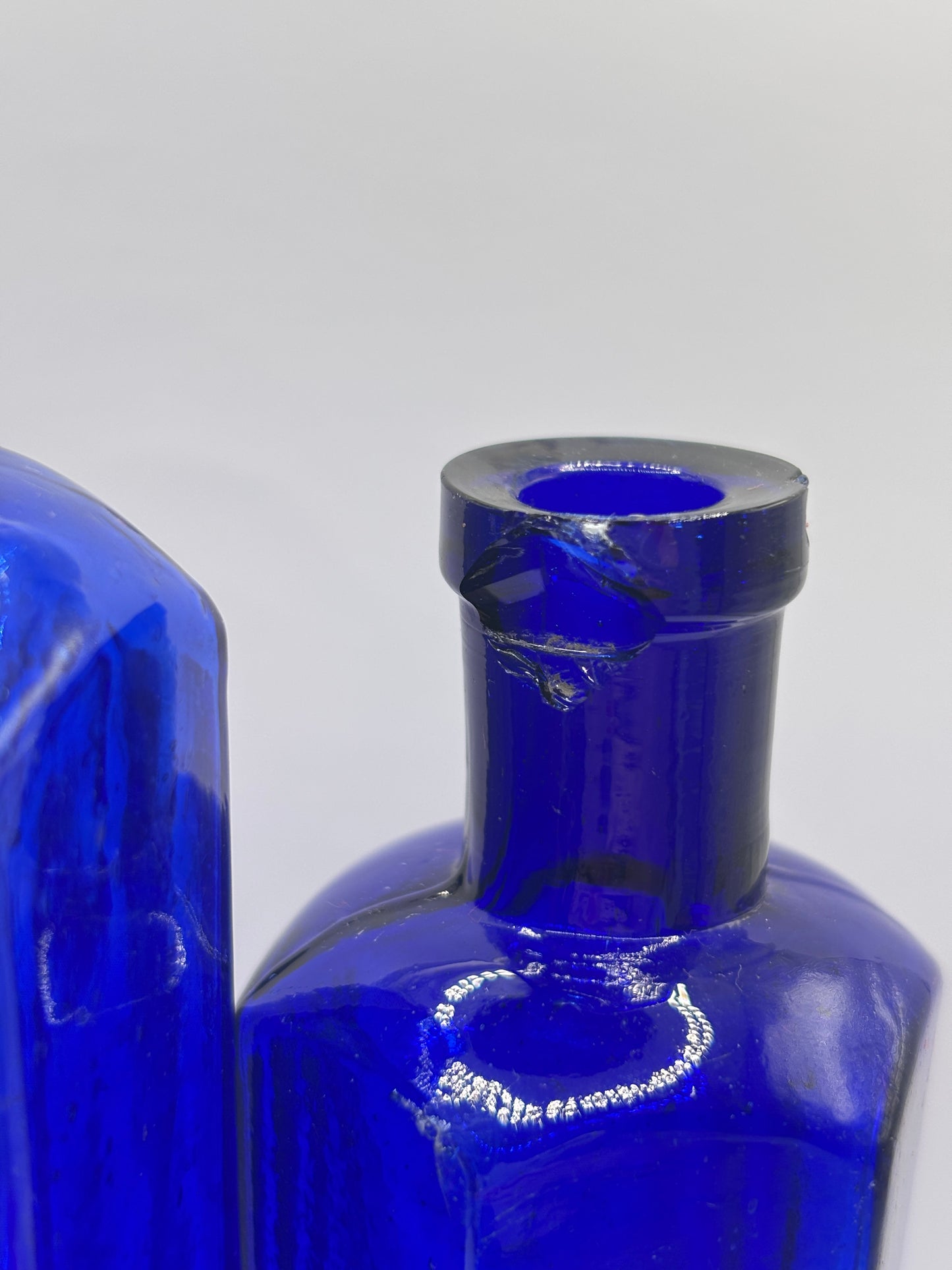 2 Old blue glass ribbed poison bottles. ‘not to be taken’ (C) damaged
