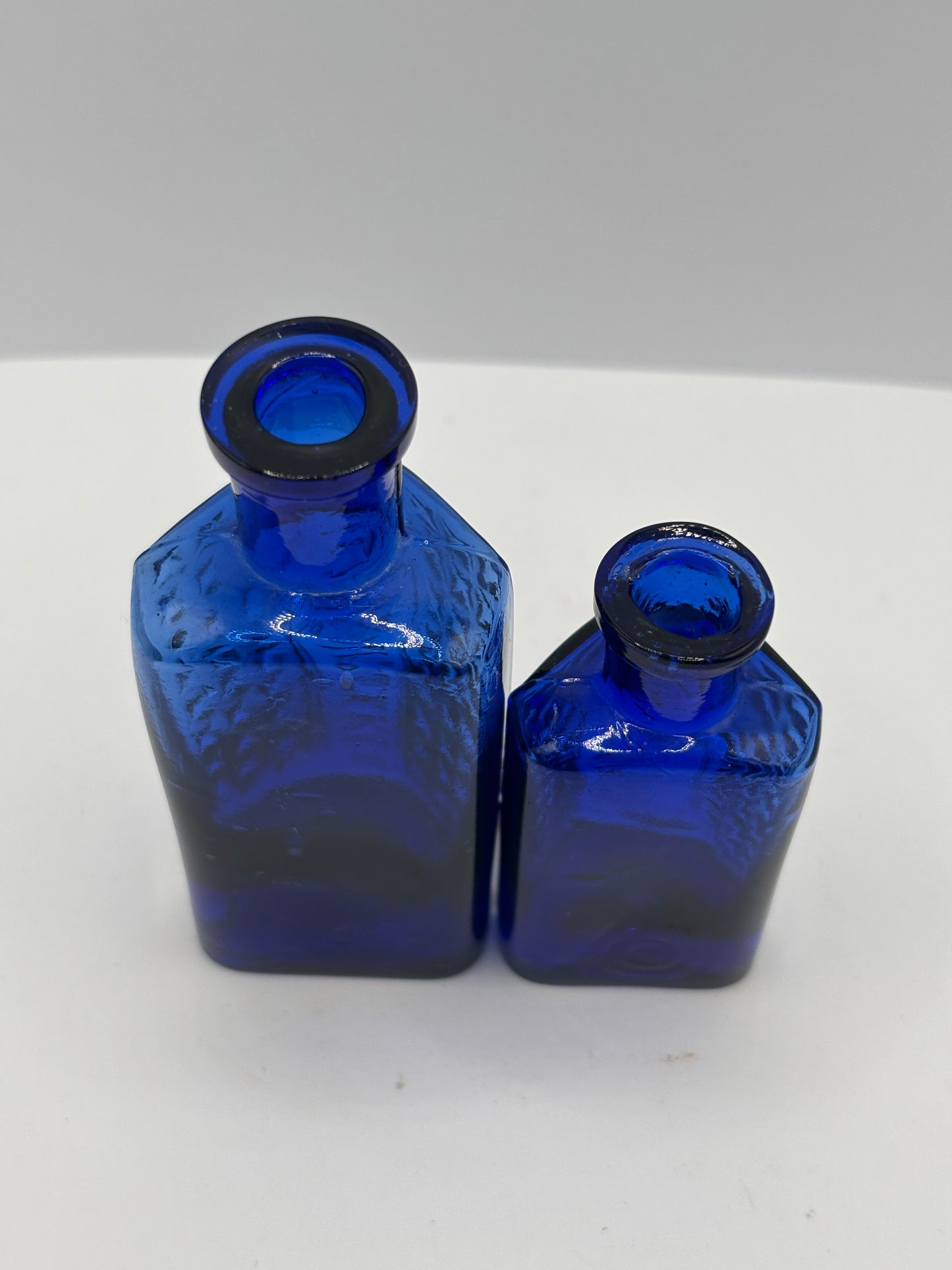 2 old blue flat back poison bottles