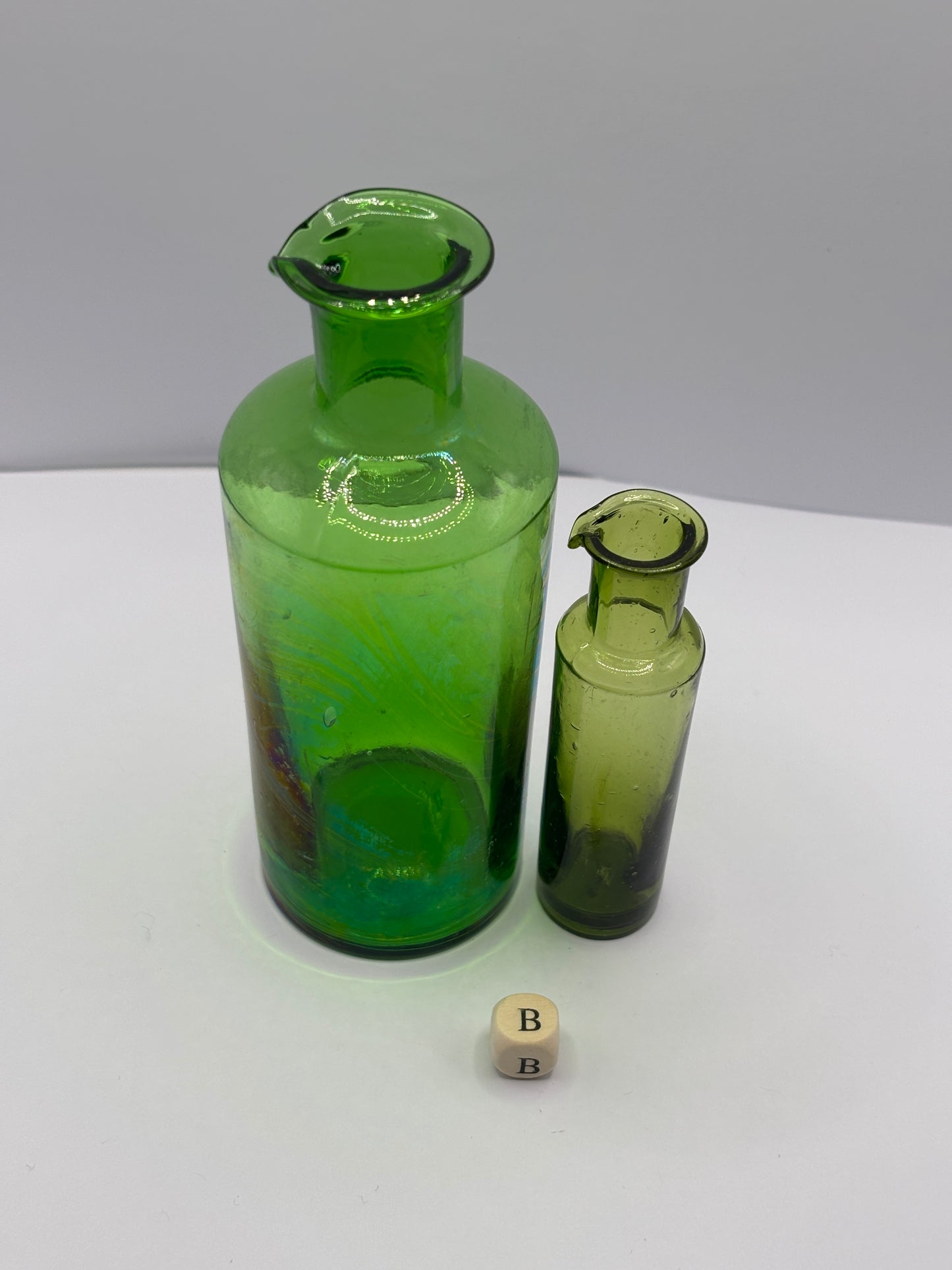 2 old green glass bottles with pouring lips (B)