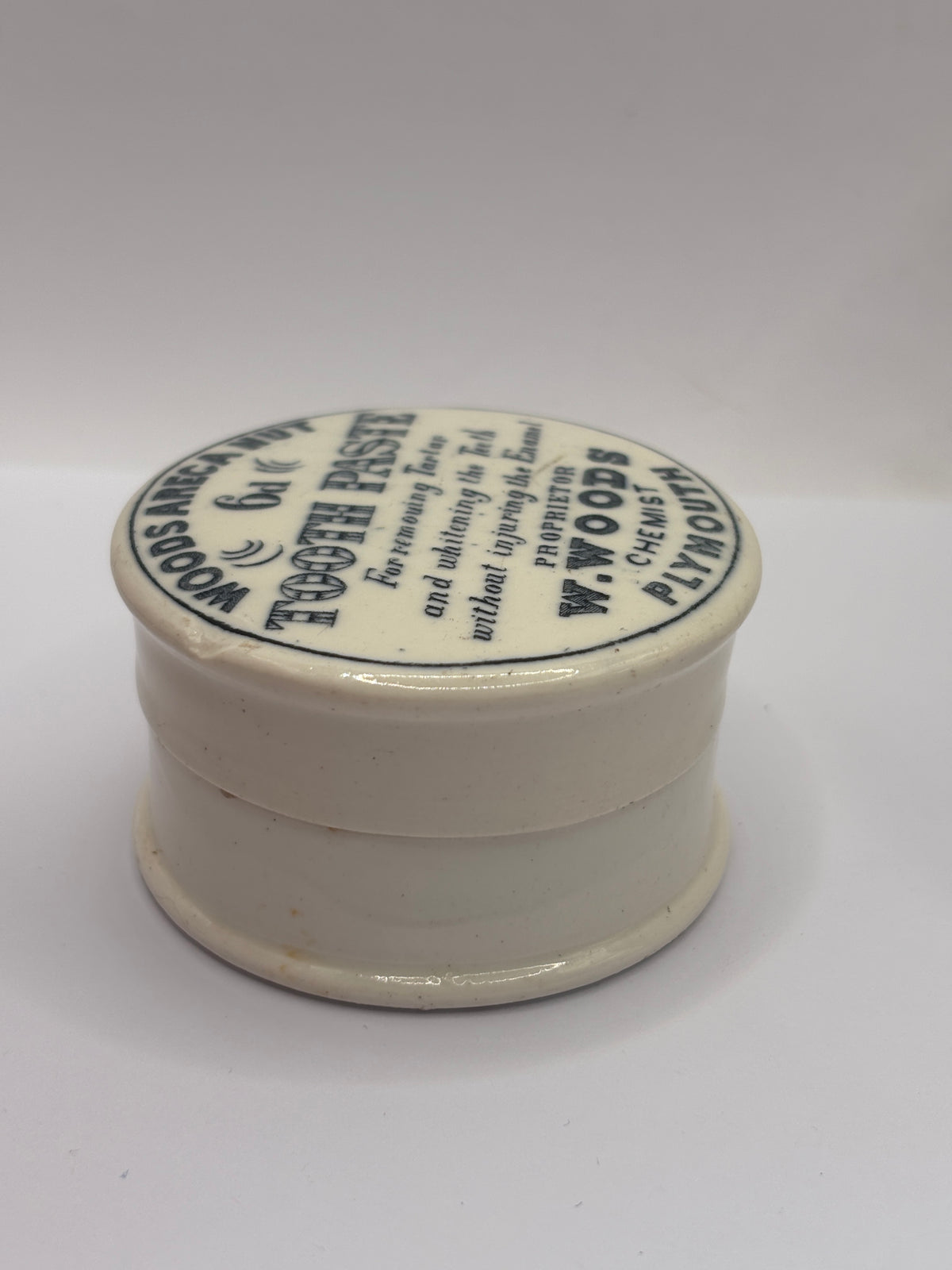Old advertising lid and base. Woods areca nut tooth paste. Damaged