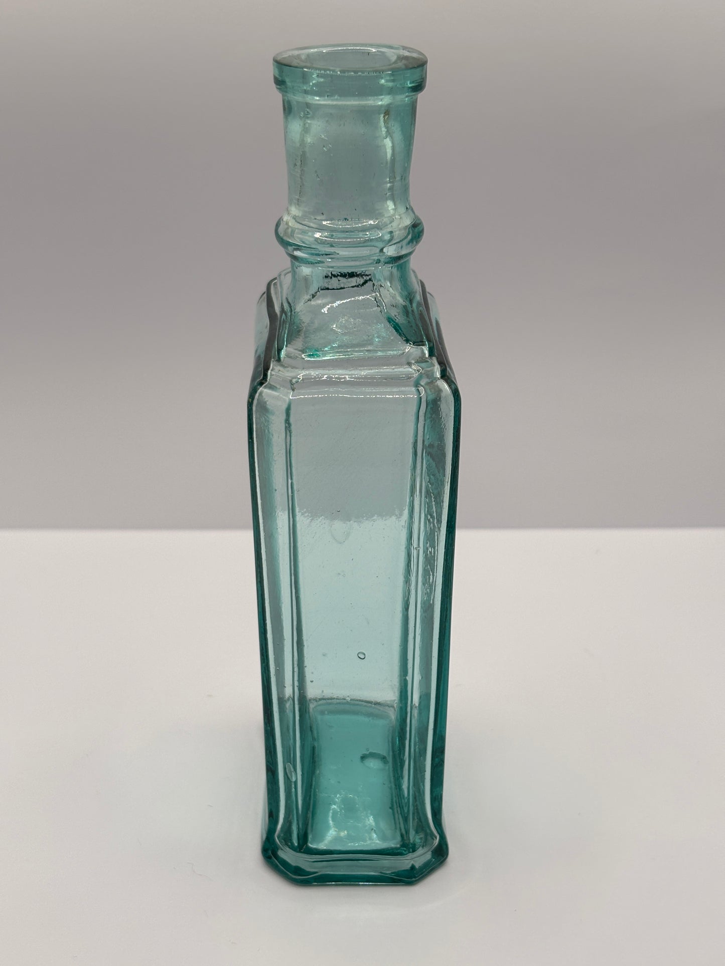 Old aqua glass advertising bottle. Perfume? Erasmic London Paris