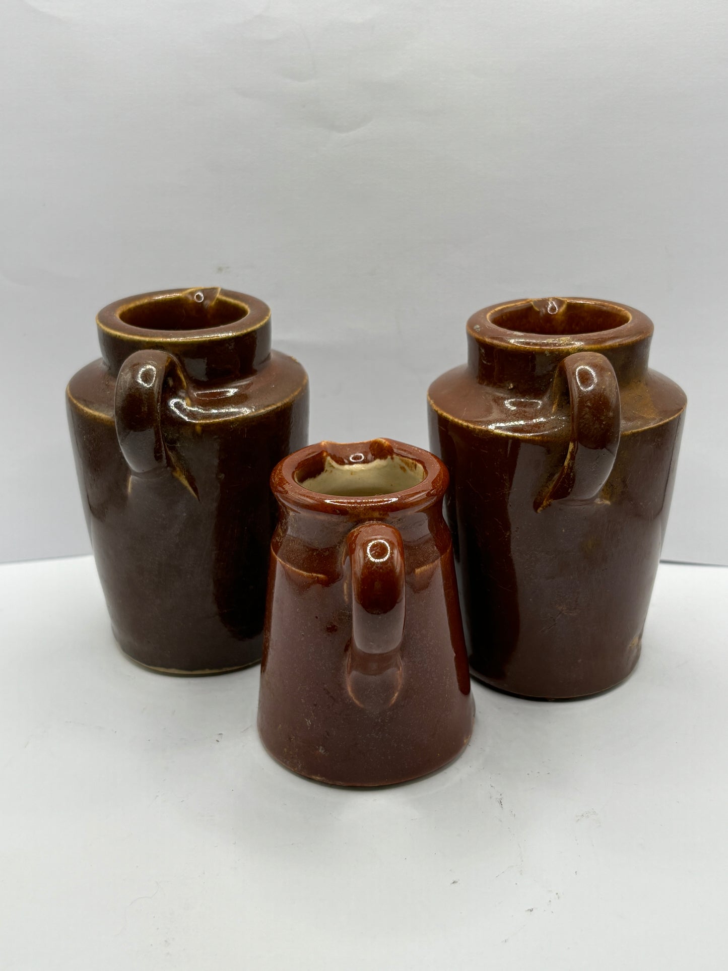 3 old brown stoneware cream pots, handled