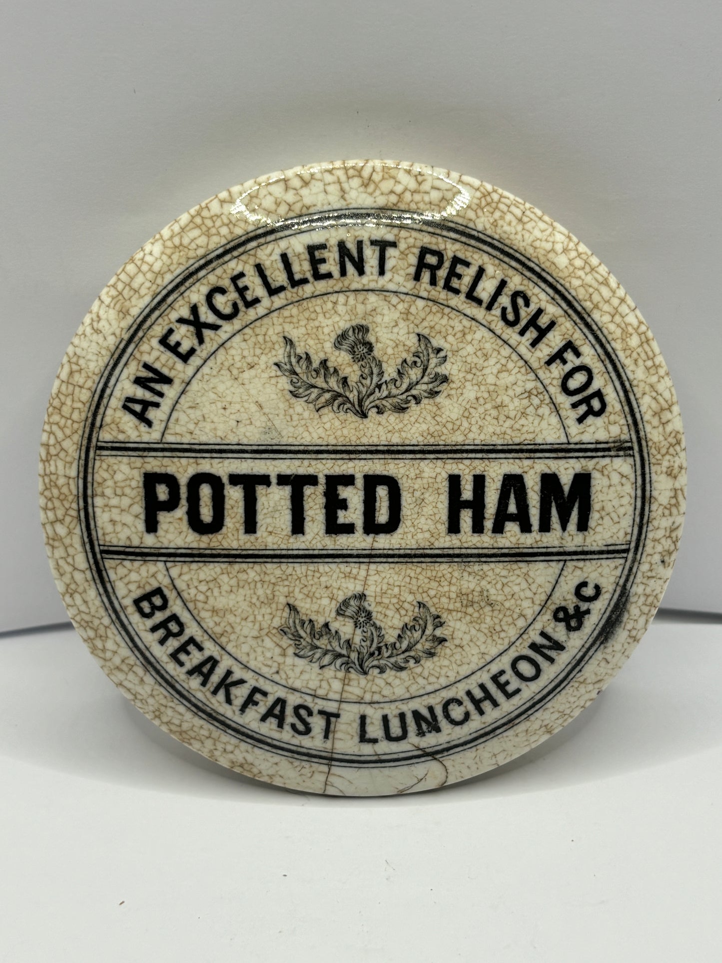 Old potted ham advertising lid, stained & crazed