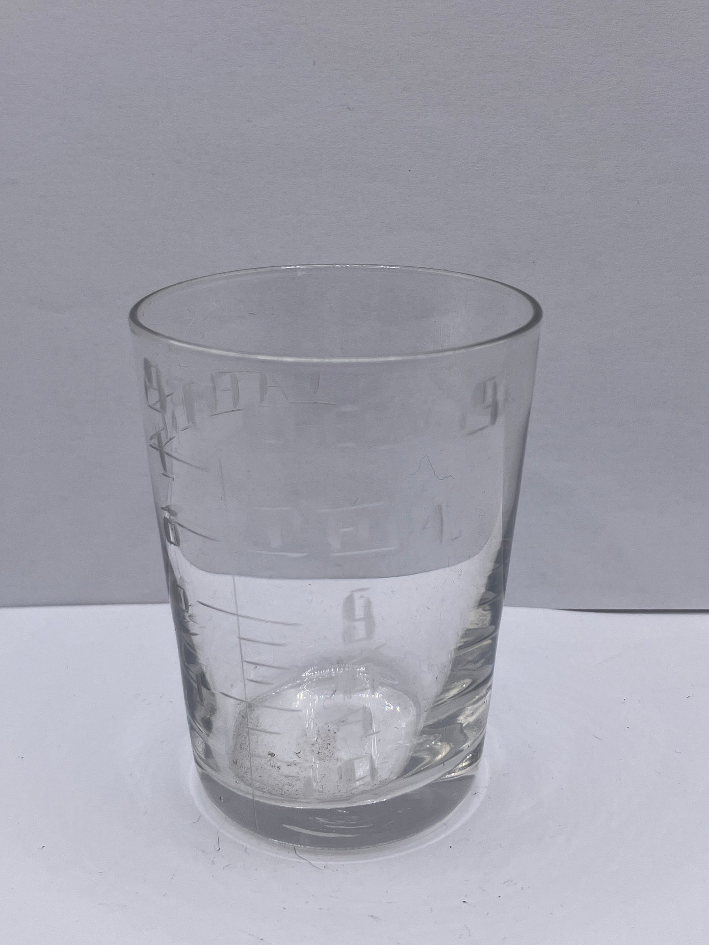 Old chemist measuring glass