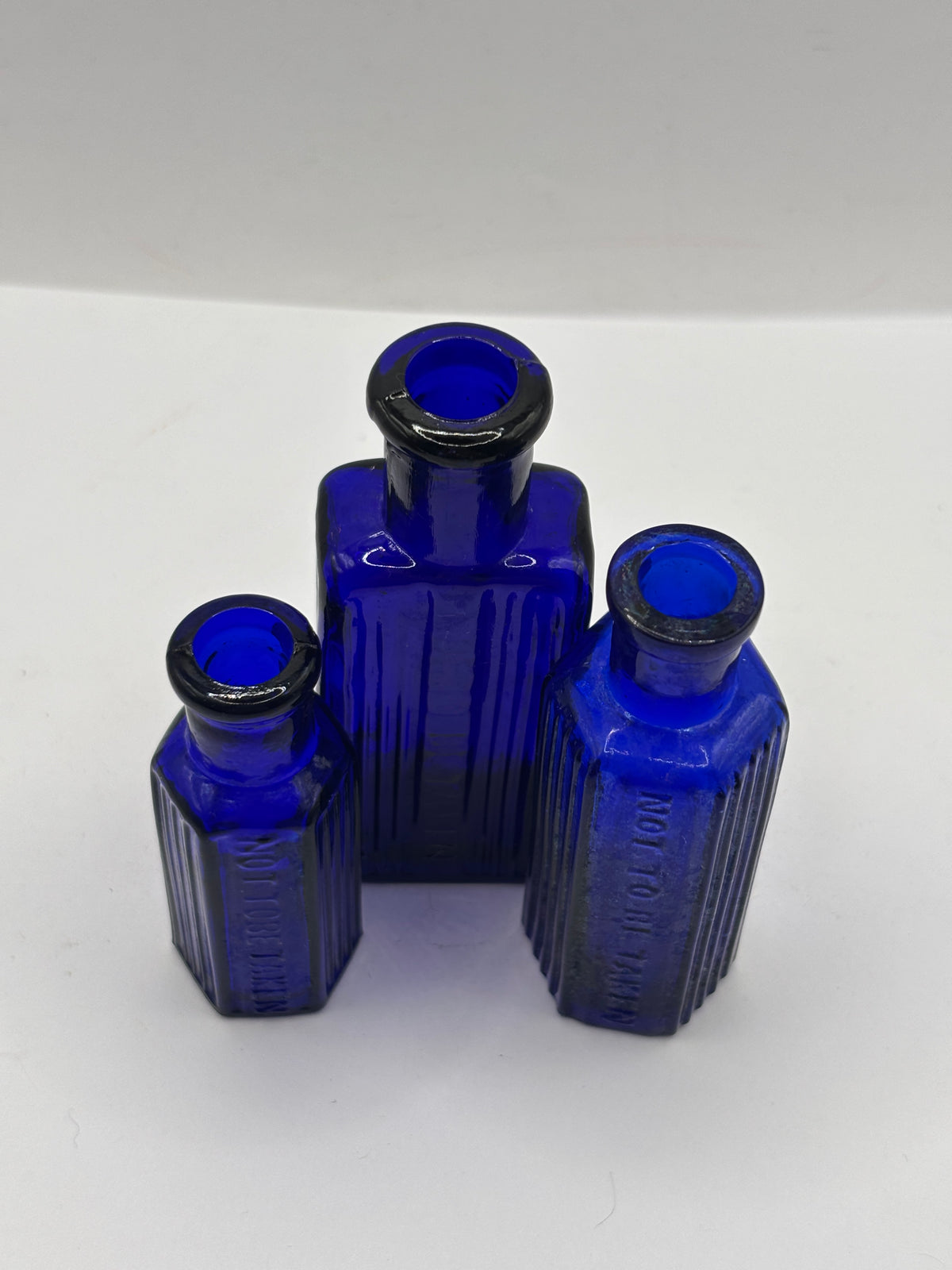 3 old small blue ribbed poison bottles, not to be taken