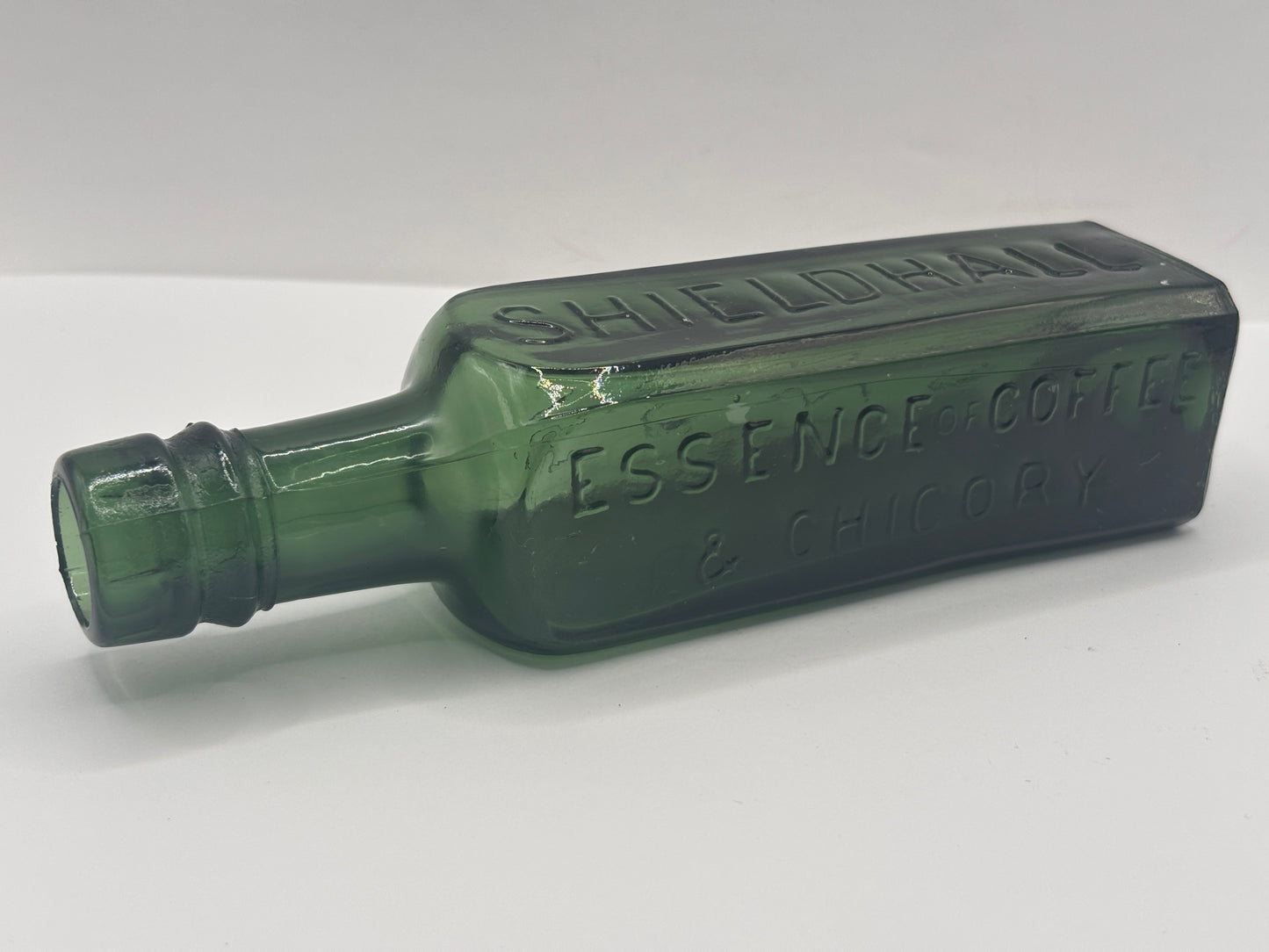 Old green glass essence of coffee & chicory bottle