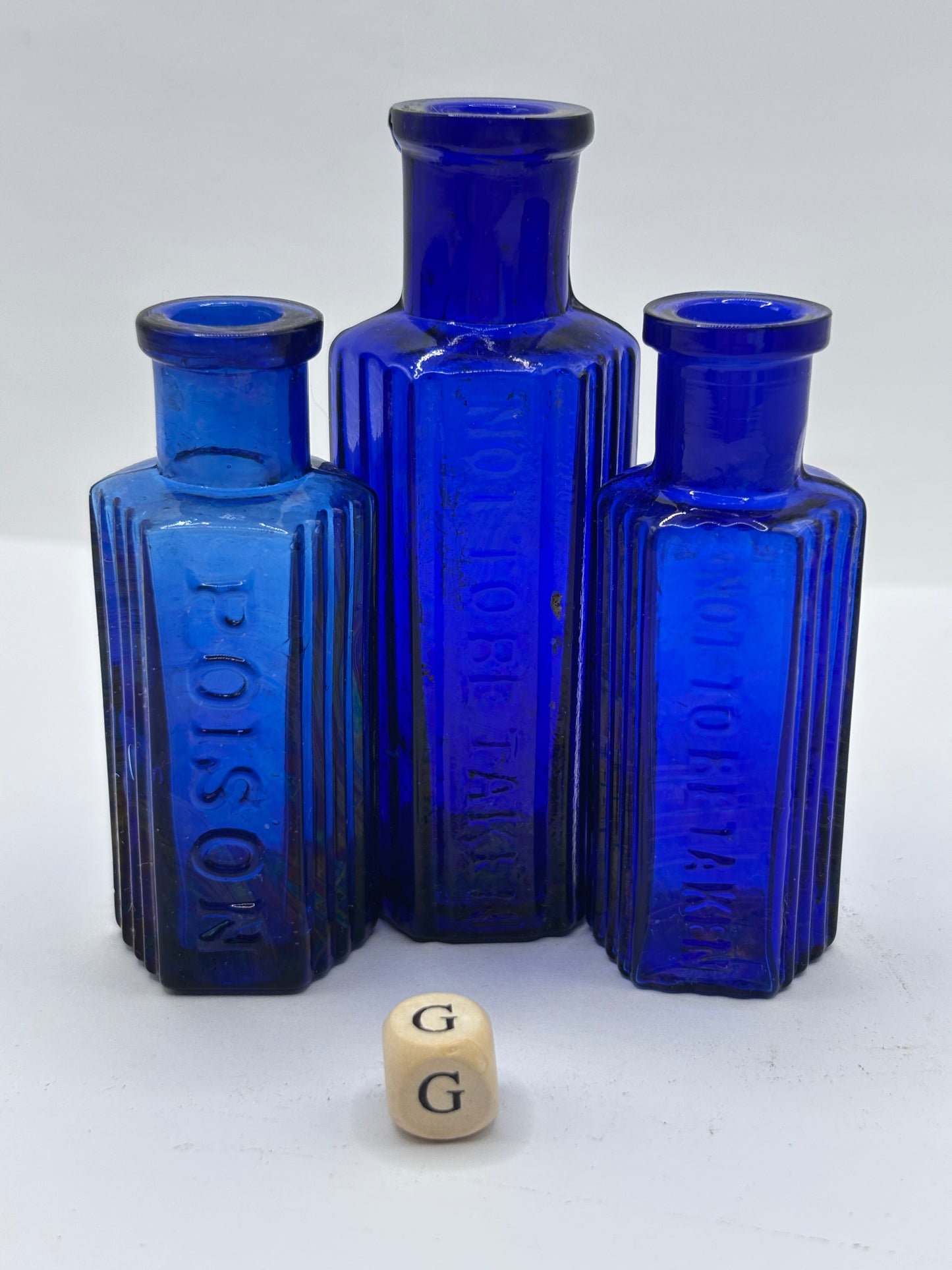 3 old blue glass poison bottles