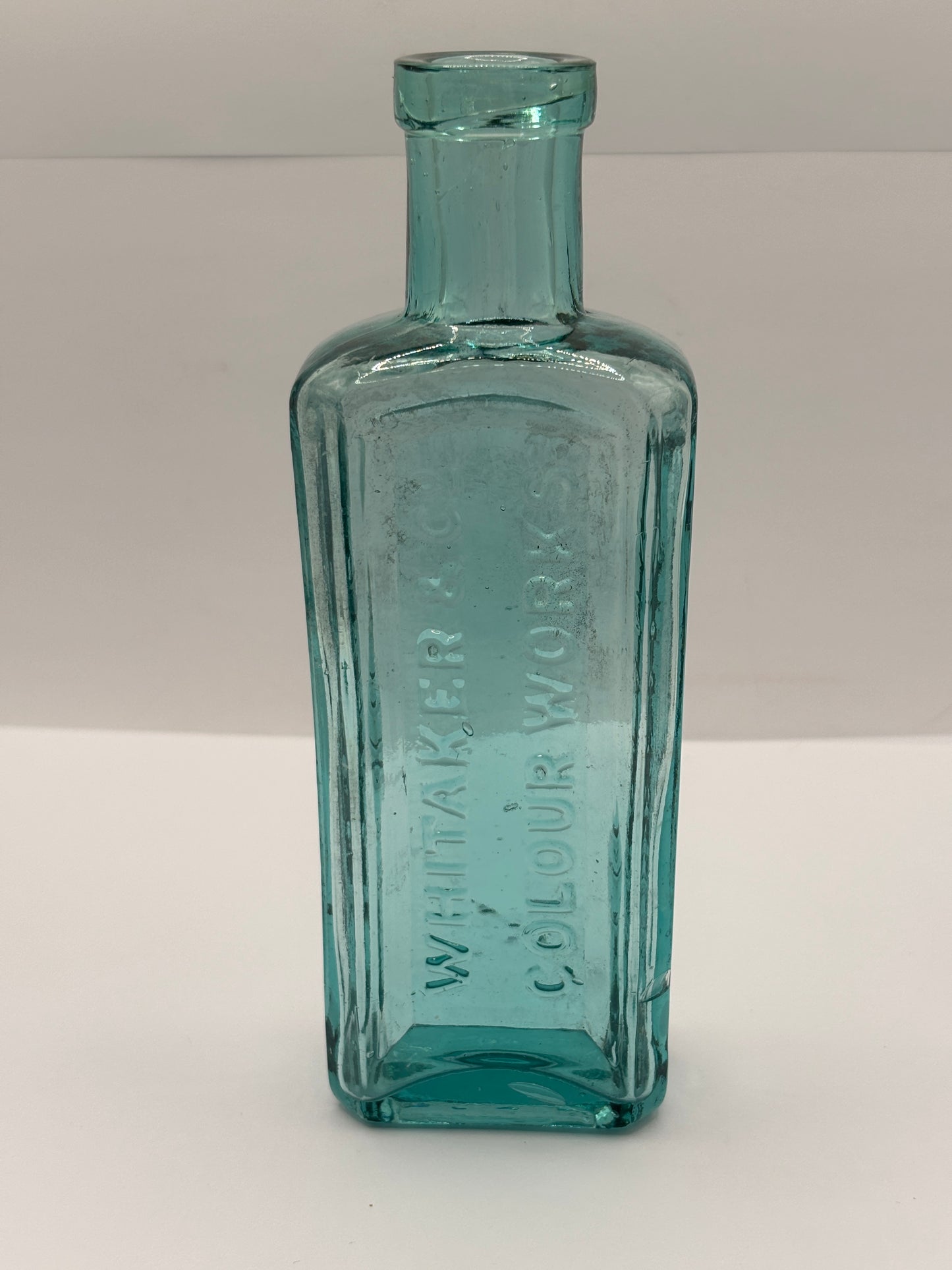 Old advertising aqua glass chemist bottle, Whittakers colour works