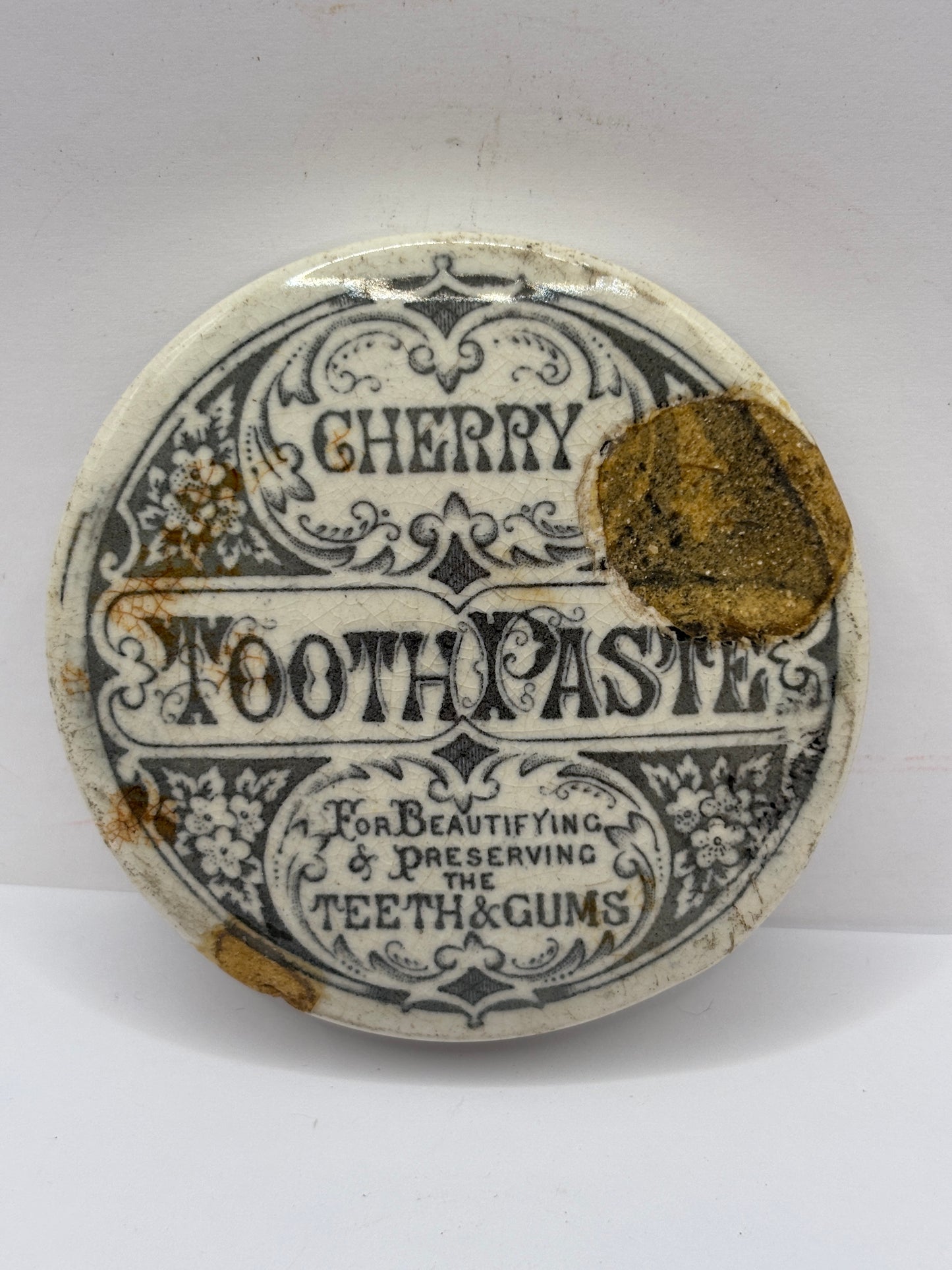 Old advertising lid, Cherry tooth paste. Damaged