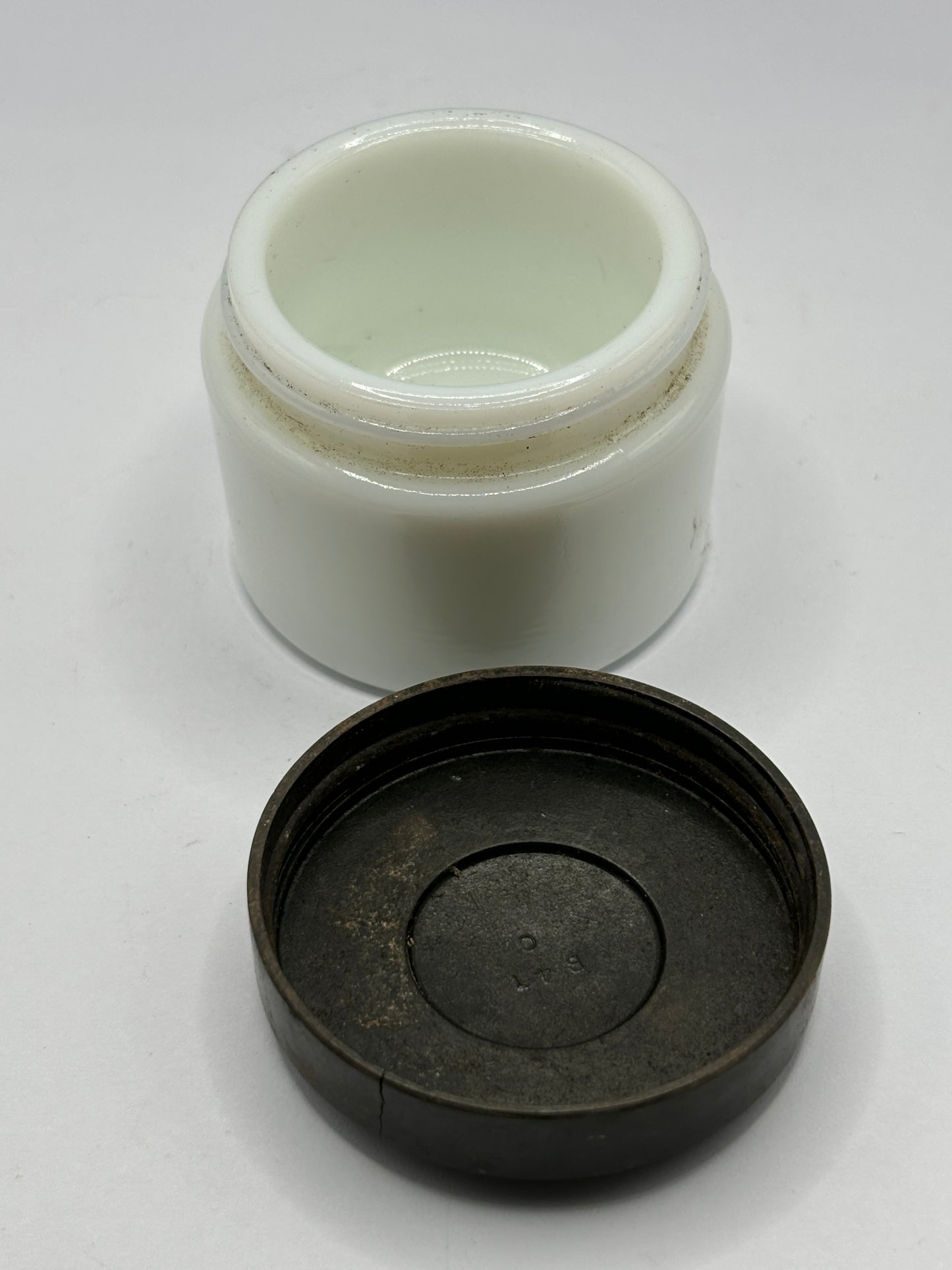 Small milk glass jar with original lid