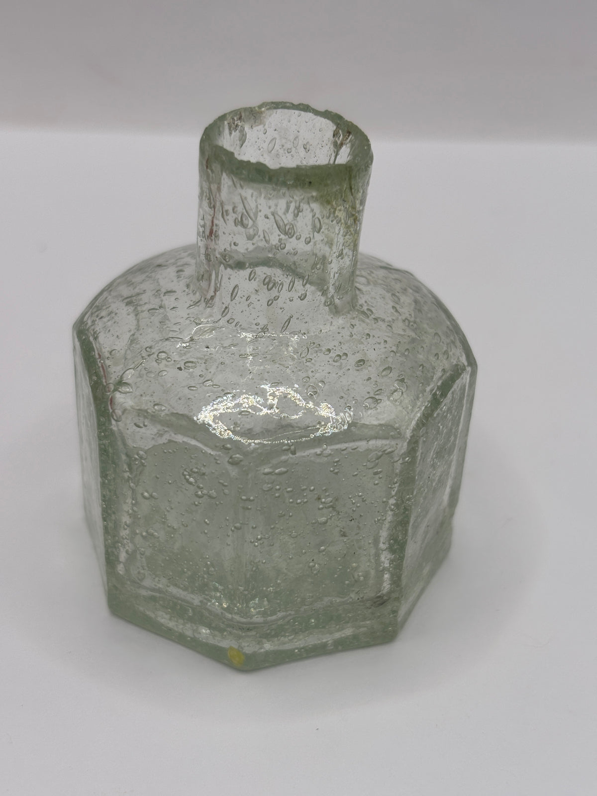 Old glass inkwell, bubbly ink