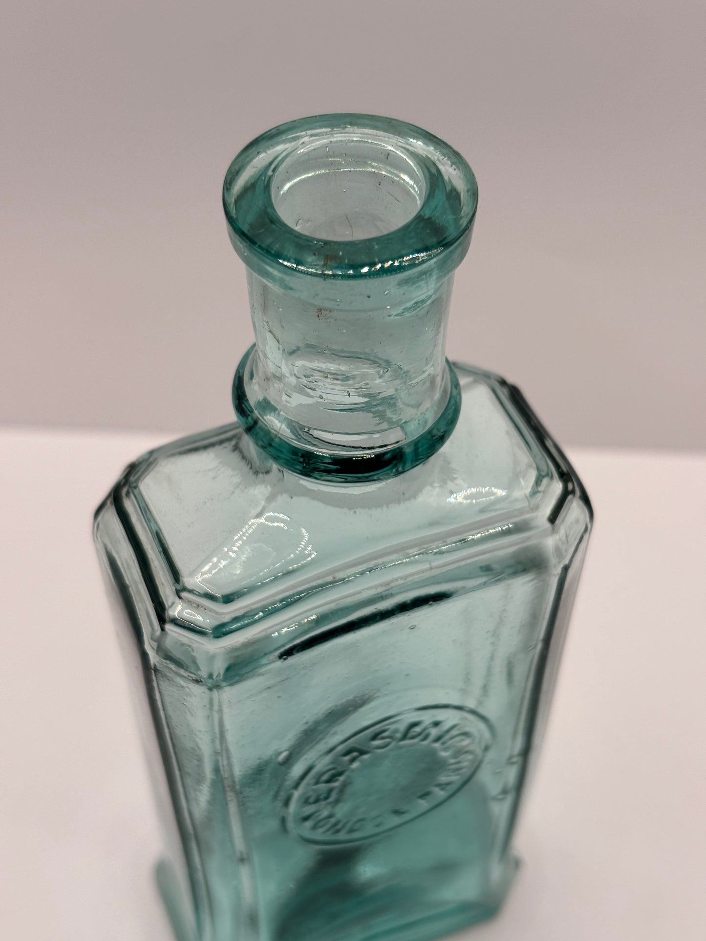 Old aqua glass advertising bottle. Perfume? Erasmic London Paris