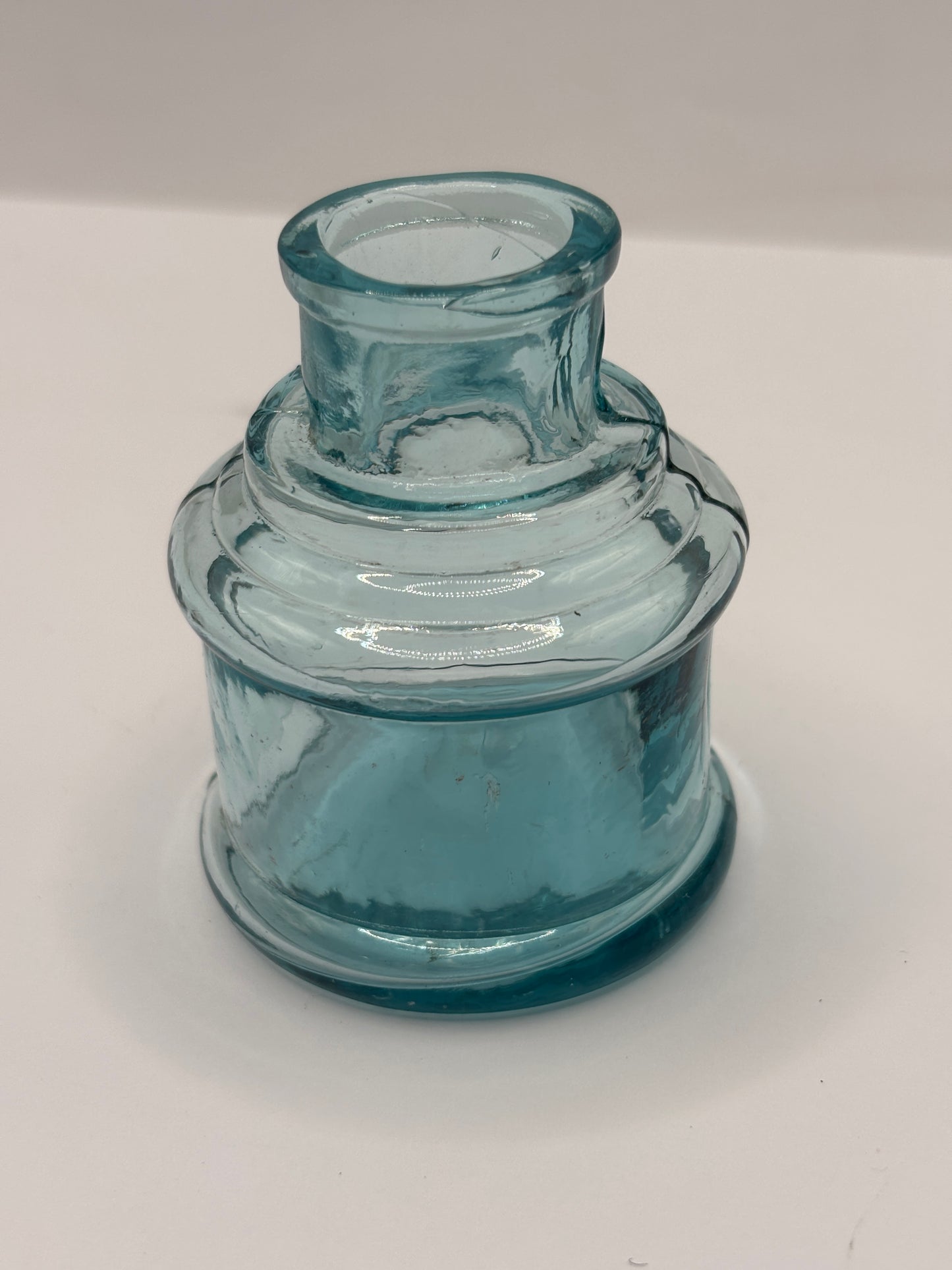 Old light blue glass inkwell, ink bottle