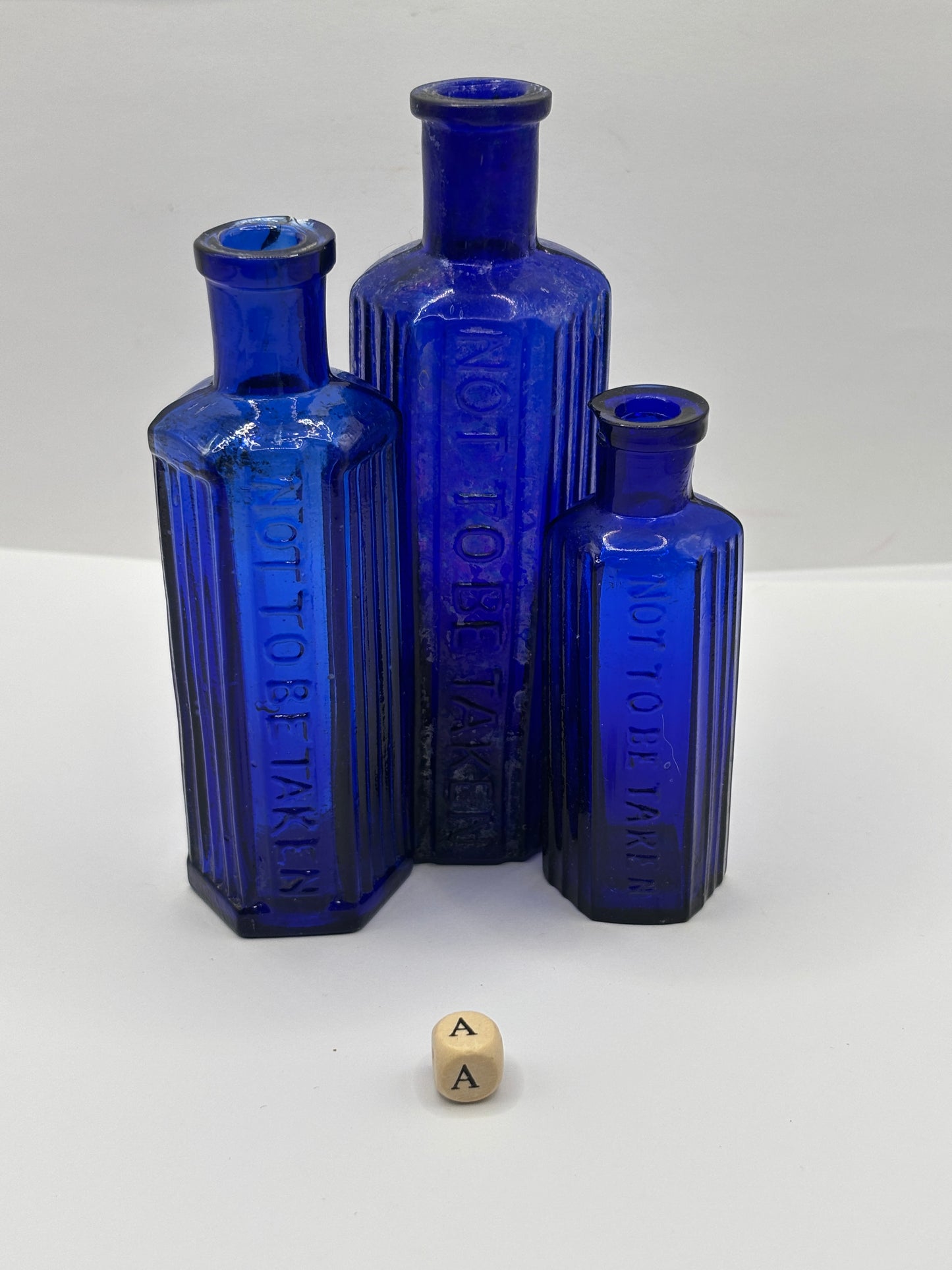 3 old blue glass poison bottles, chipped & crusty (a)
