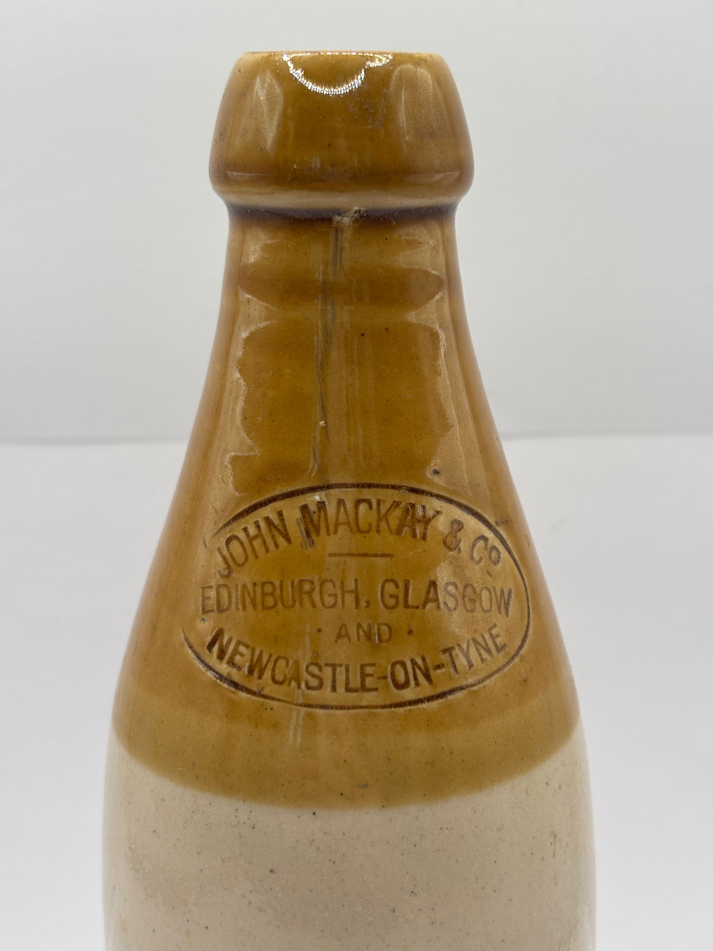 Old stoneware stout bottle, John Mackay & Co