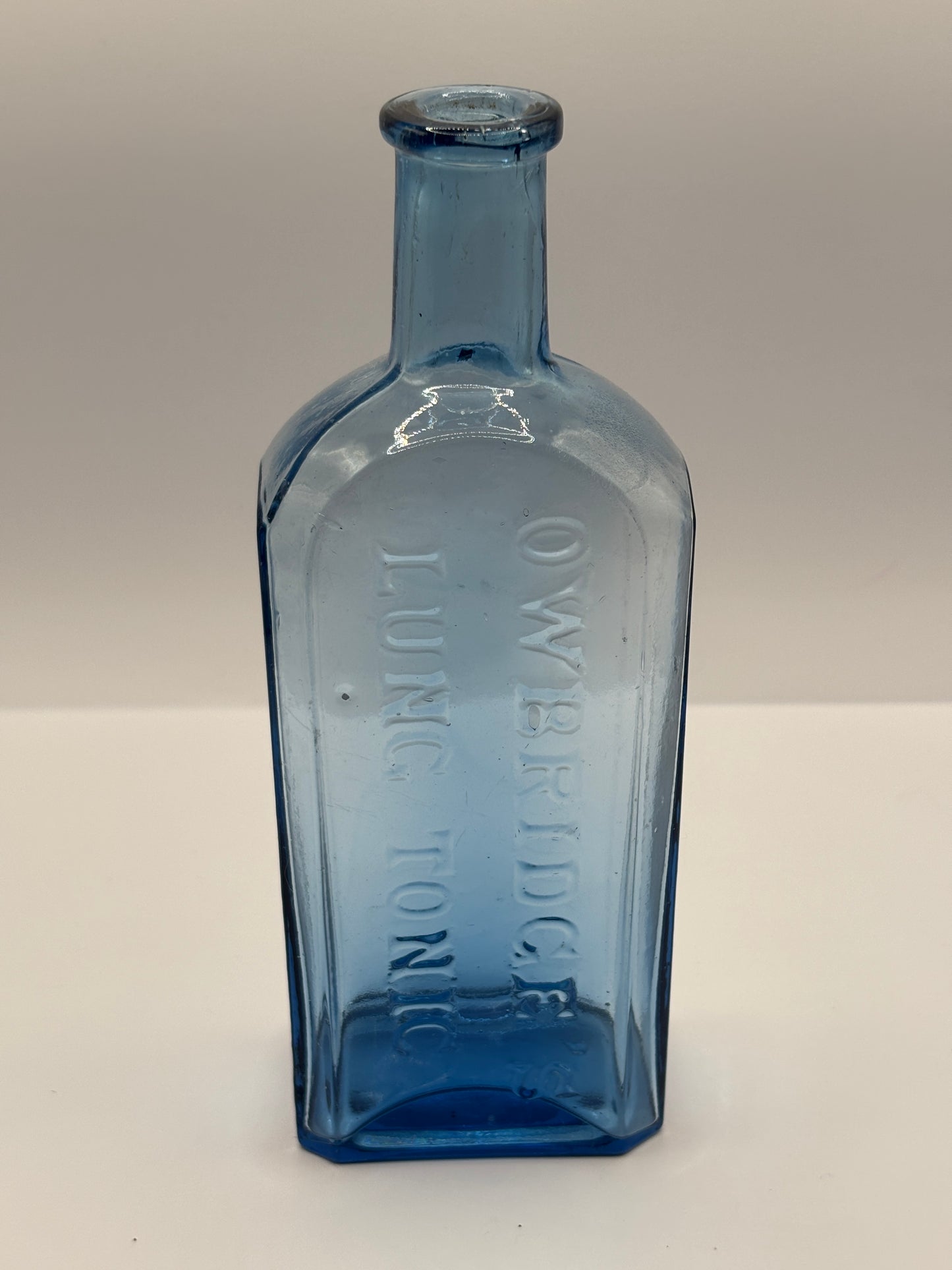 Old blue glass advertising chemist bottle, Owbridge Lung Tonic