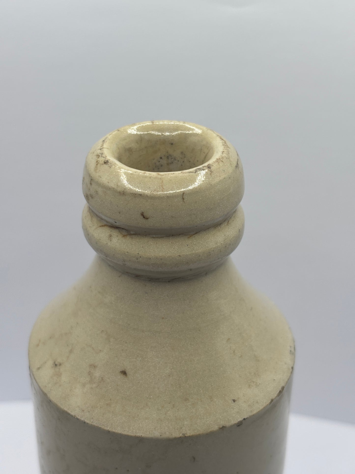 Old white stoneware Belle vue ginger beer bottle