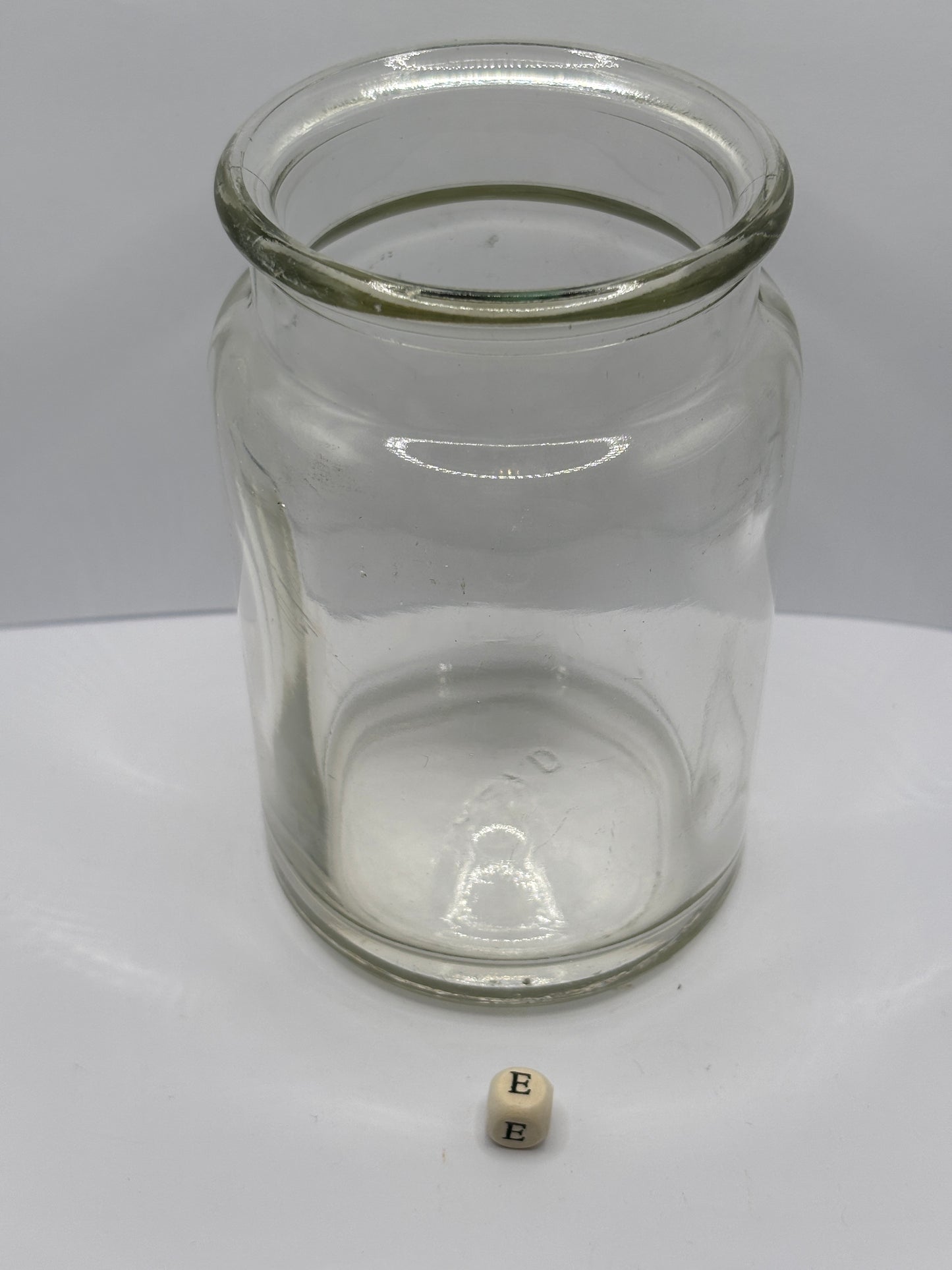 Old clear glass jam jar (e)