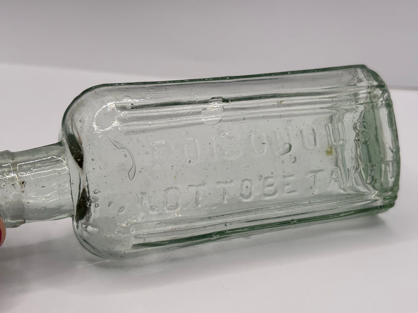 Old aqua glass poison bottle, Poisonous
