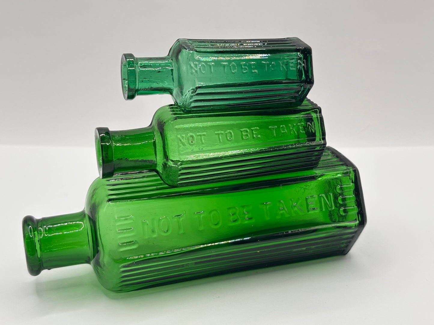 3 Old green glass poison bottles, not to be taken