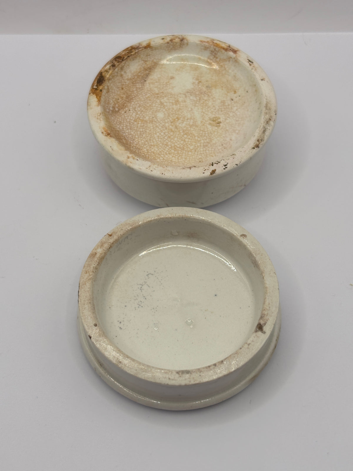 Old advertising lid and base. Woods areca nut tooth paste. Damaged