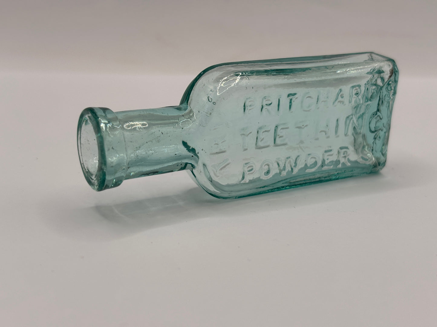 Old aqua glass advertising bottle. Try Pritchards teething powders