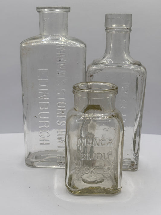 3 old clear glass advertising bottles