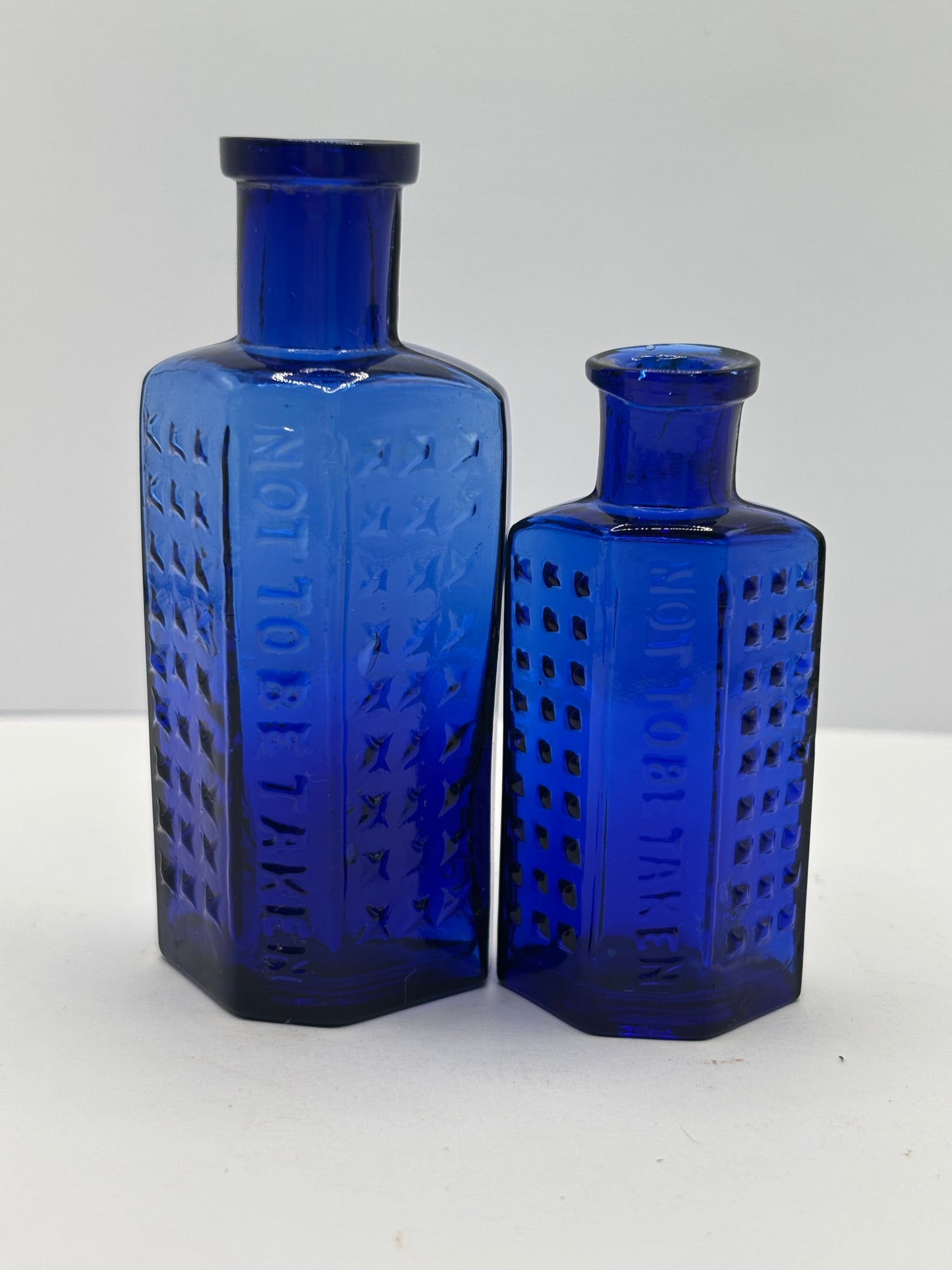 2 old blue flat back poison bottles
