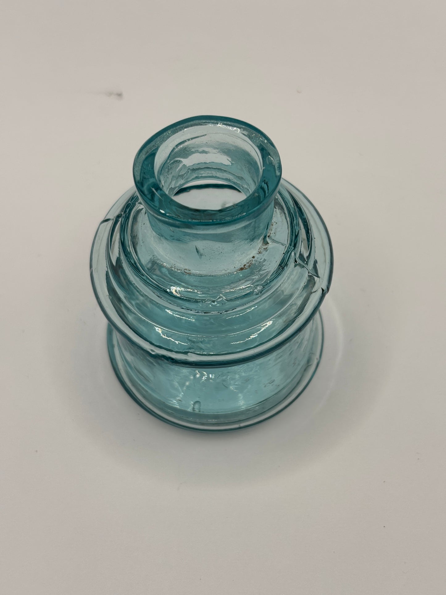 Old light blue glass inkwell, ink bottle