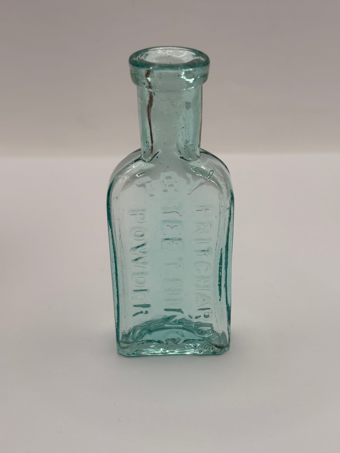 Old aqua glass advertising bottle. Try Pritchards teething powders