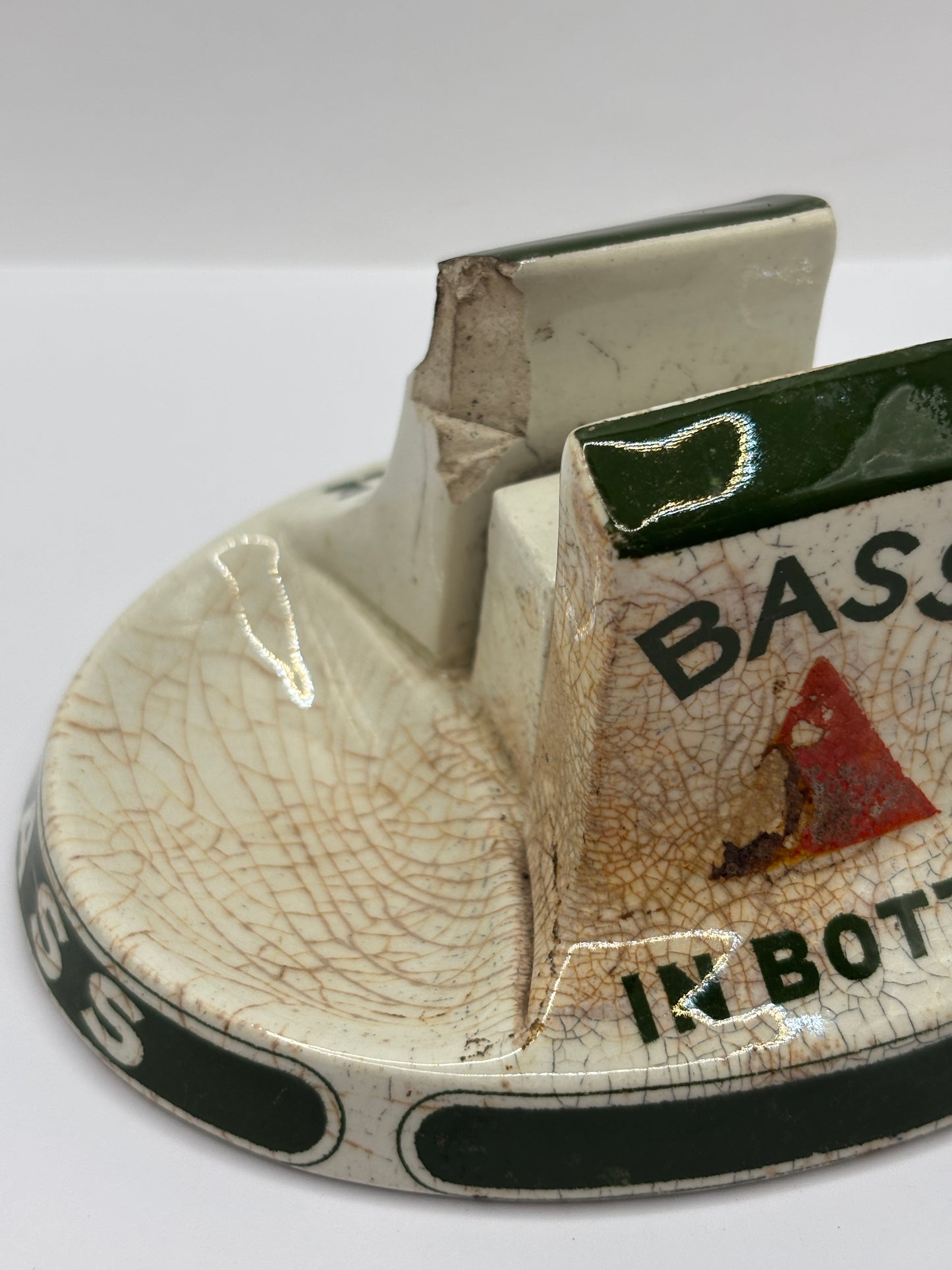 Old stoneware match striker. Bass bottled beer. Damages