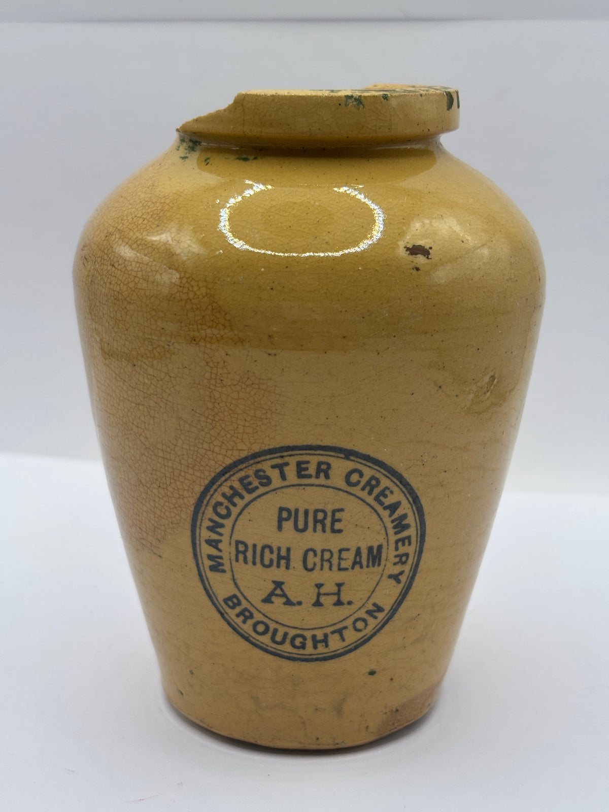 Old advertising cream pot,  Manchester creamery. Damaged