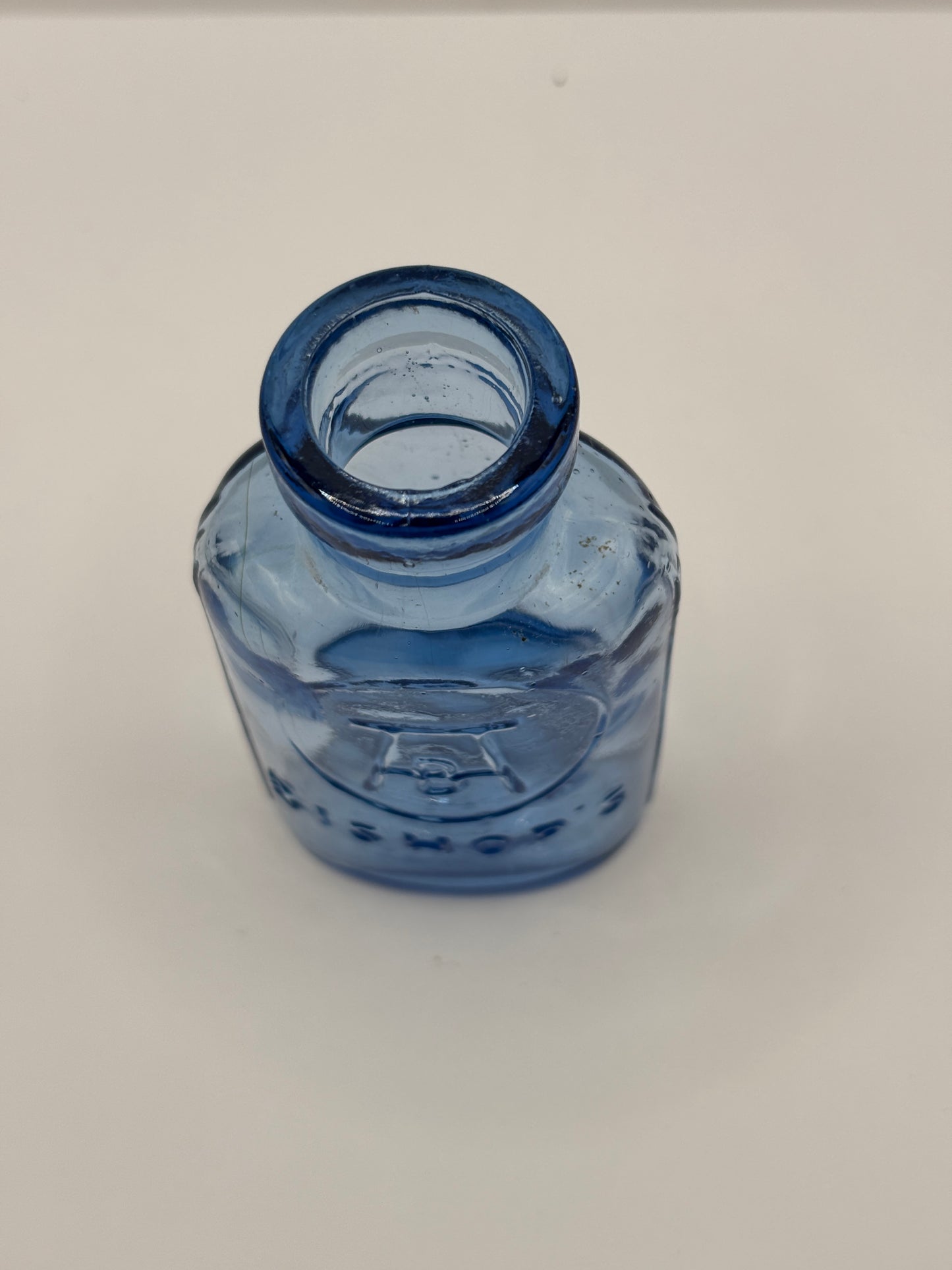 Old small blue glass advertising chemist bottle, Bishop