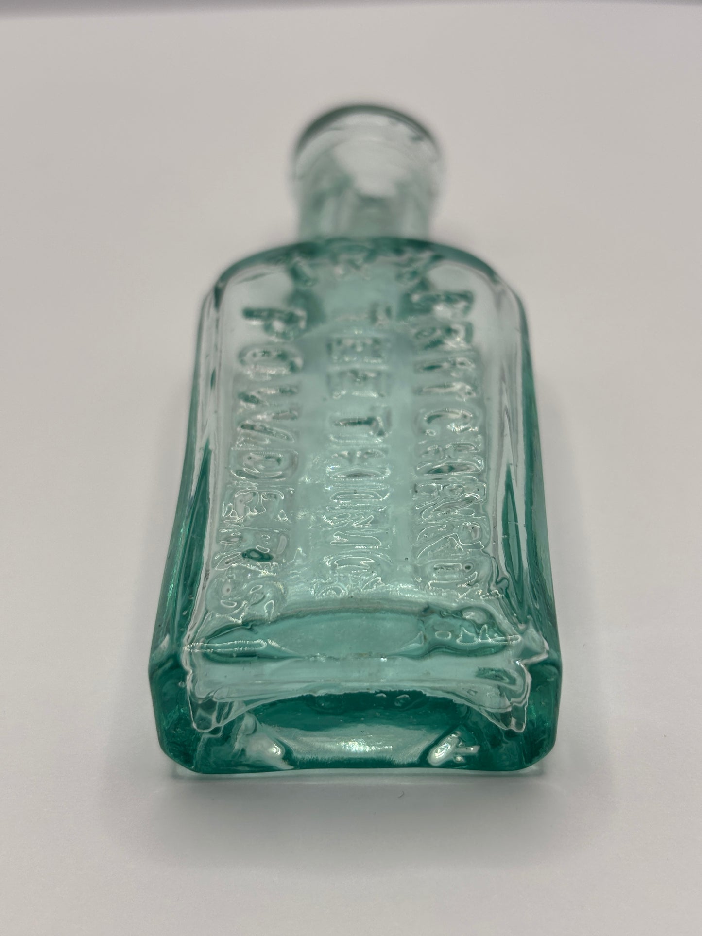 Old aqua glass advertising chemist bottle. Pritchards teething powder