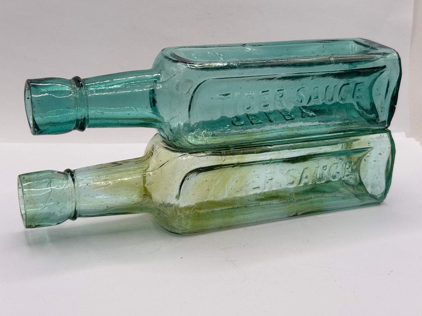 2 old aqua glass sauce bottles, Fletcher’s tiger sauce