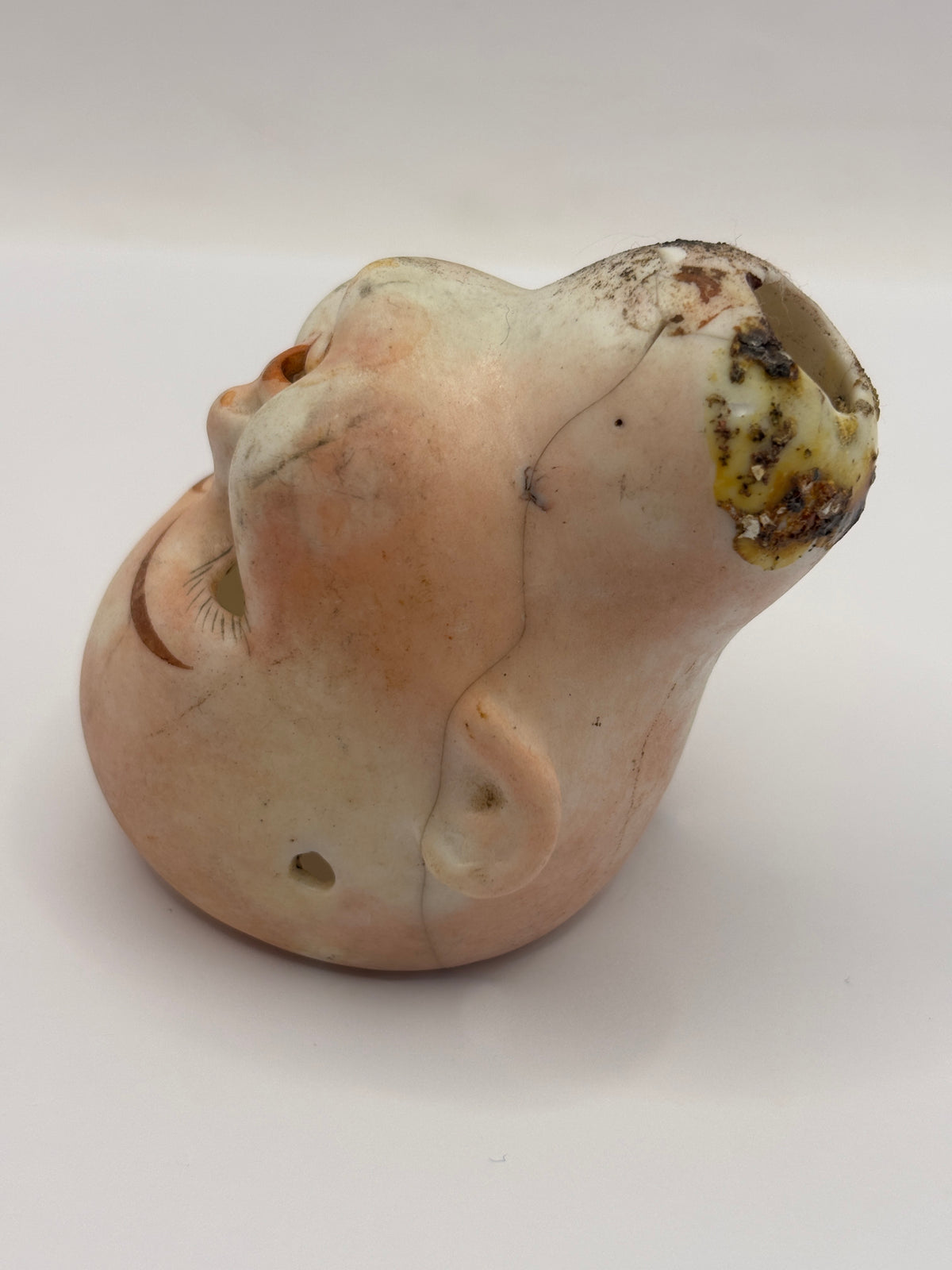 Old super stained bisque dolls head, damaged