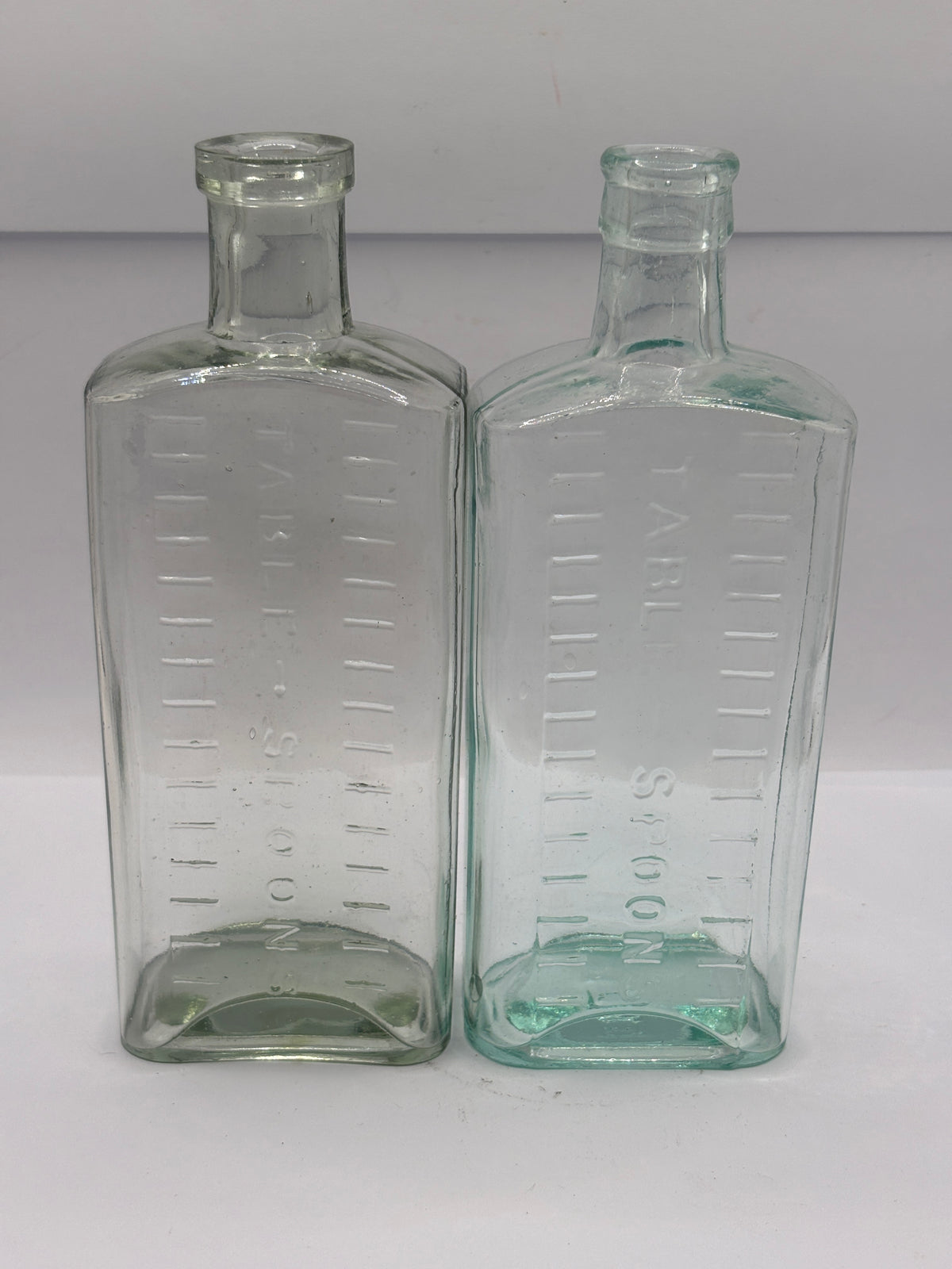 2 old aqua glass medicine bottles, table spoons
