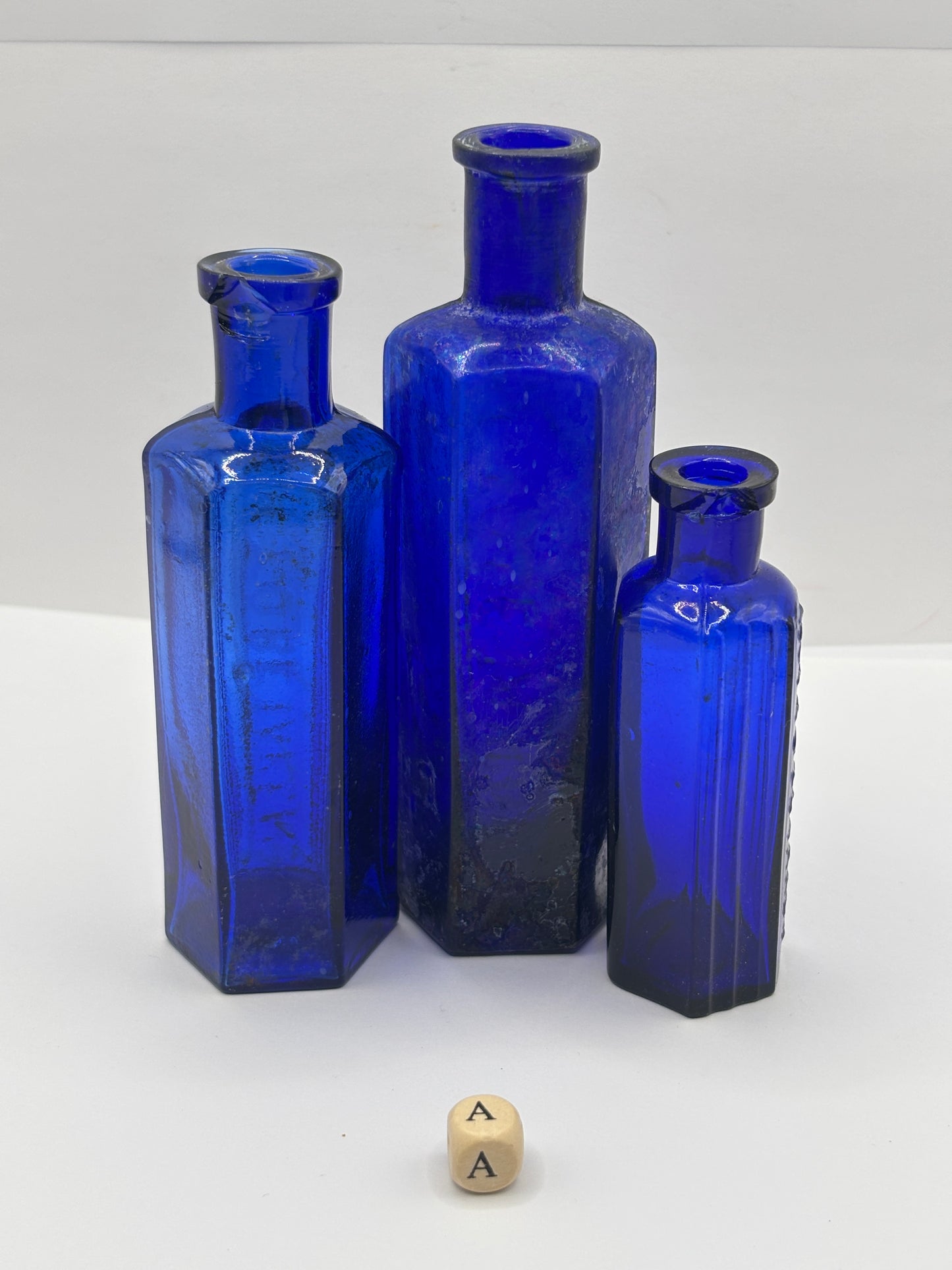 3 old blue glass poison bottles, chipped & crusty (a)